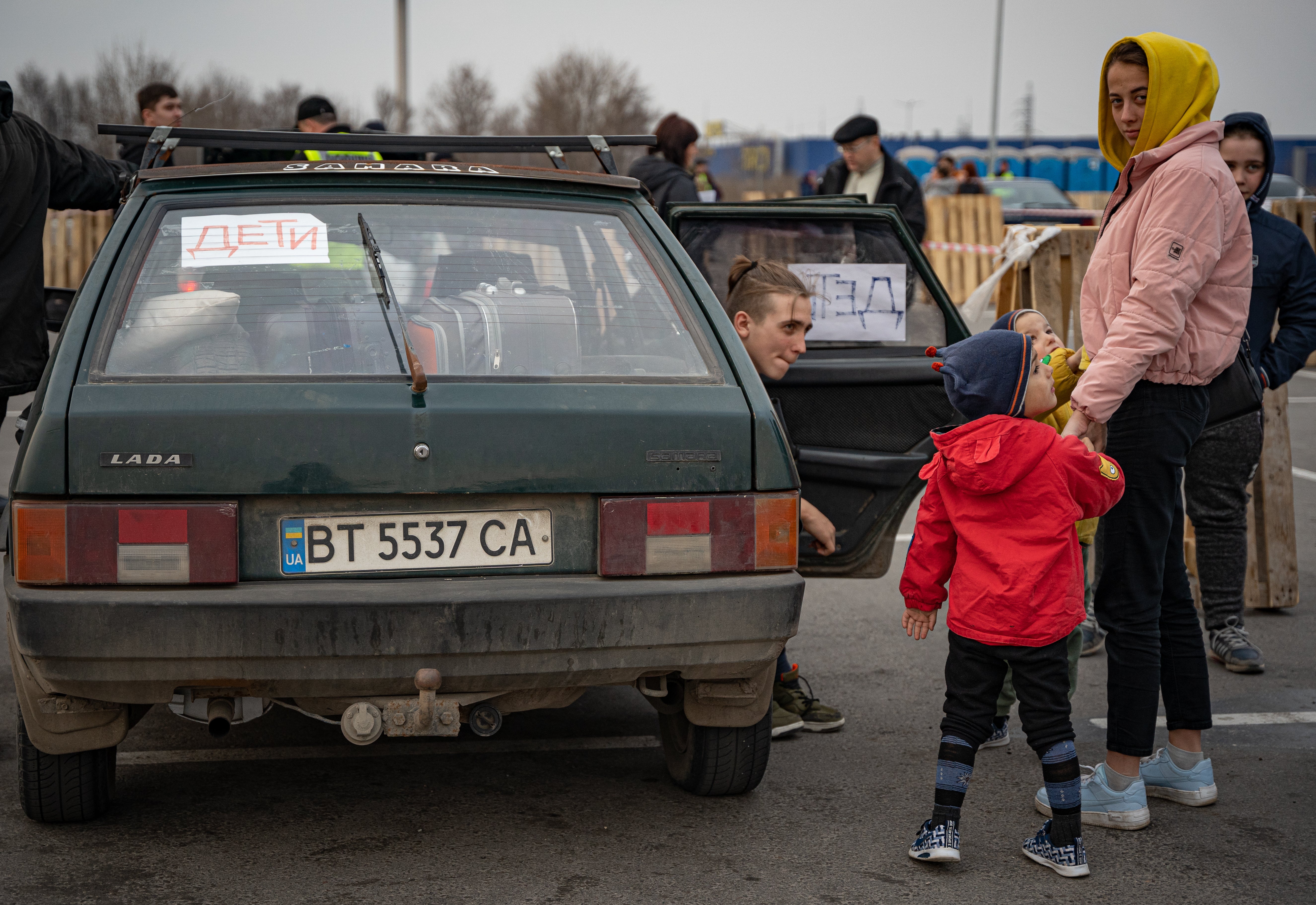 ‘Children’ is written in Russian on a placard inside a car a family just used to flee Mariupol under shelling