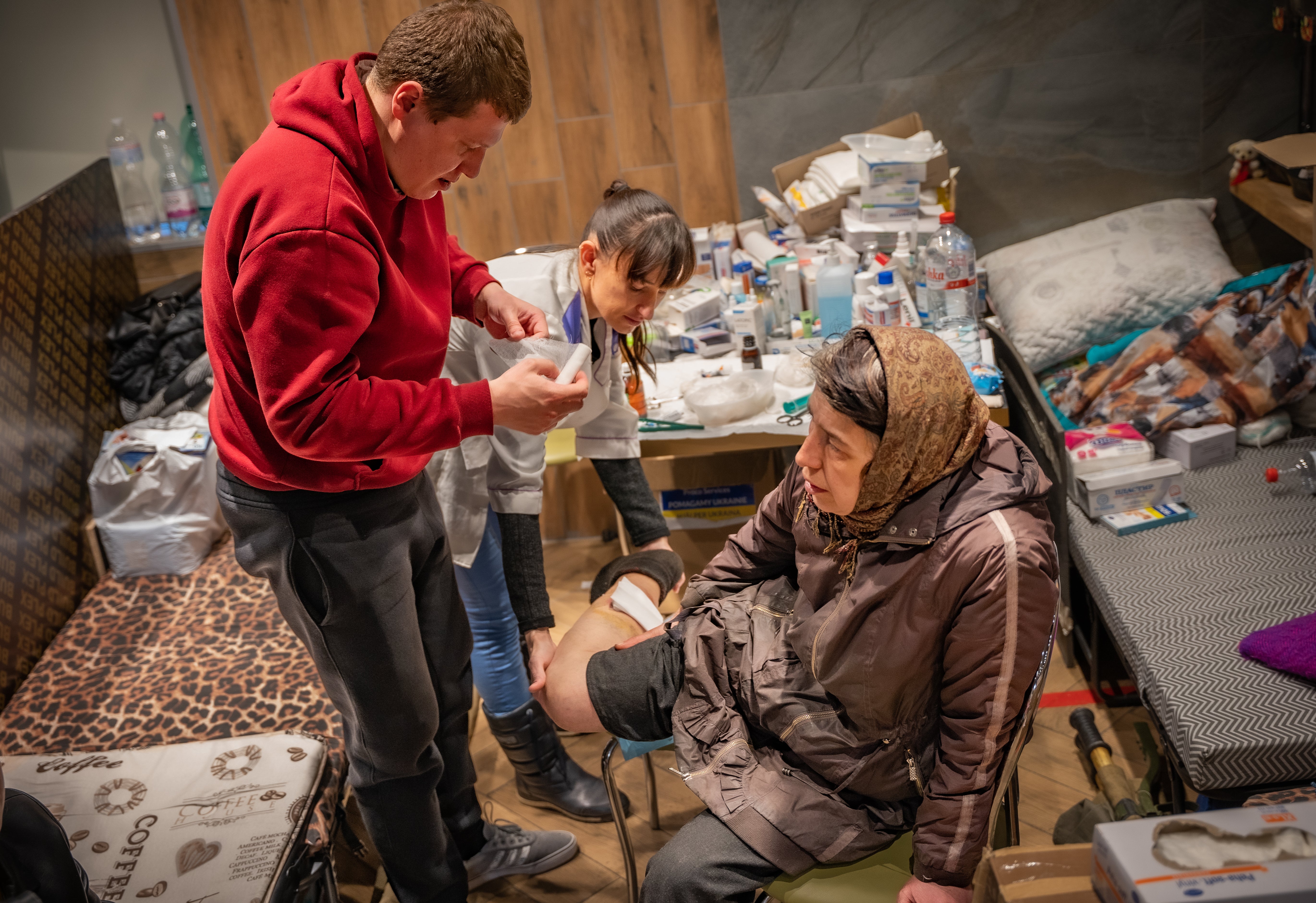 Nadezhda, 57, is treated by volunteers for wounds sustained during shelling in Mariupol. She spent a week underground before finally managing to escape