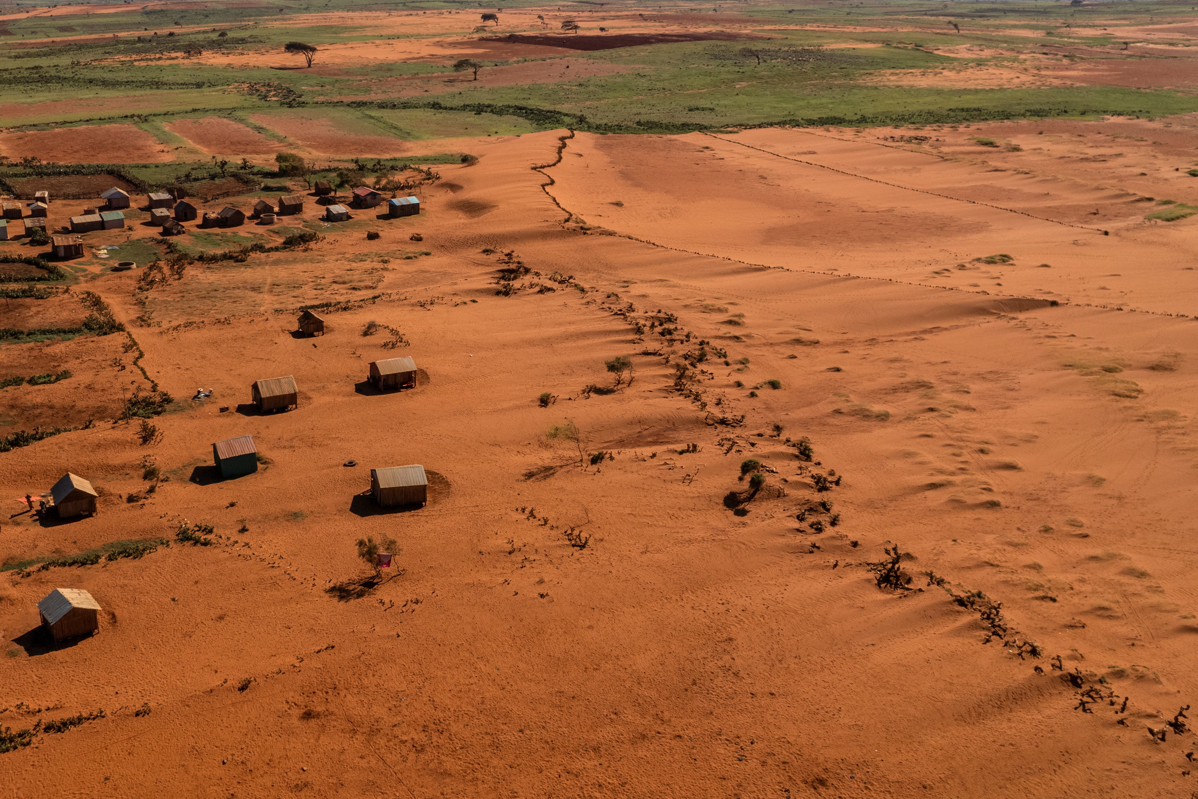 Sand begins to surround houses close to the town of Ambovombe, Androy region, Madagascar