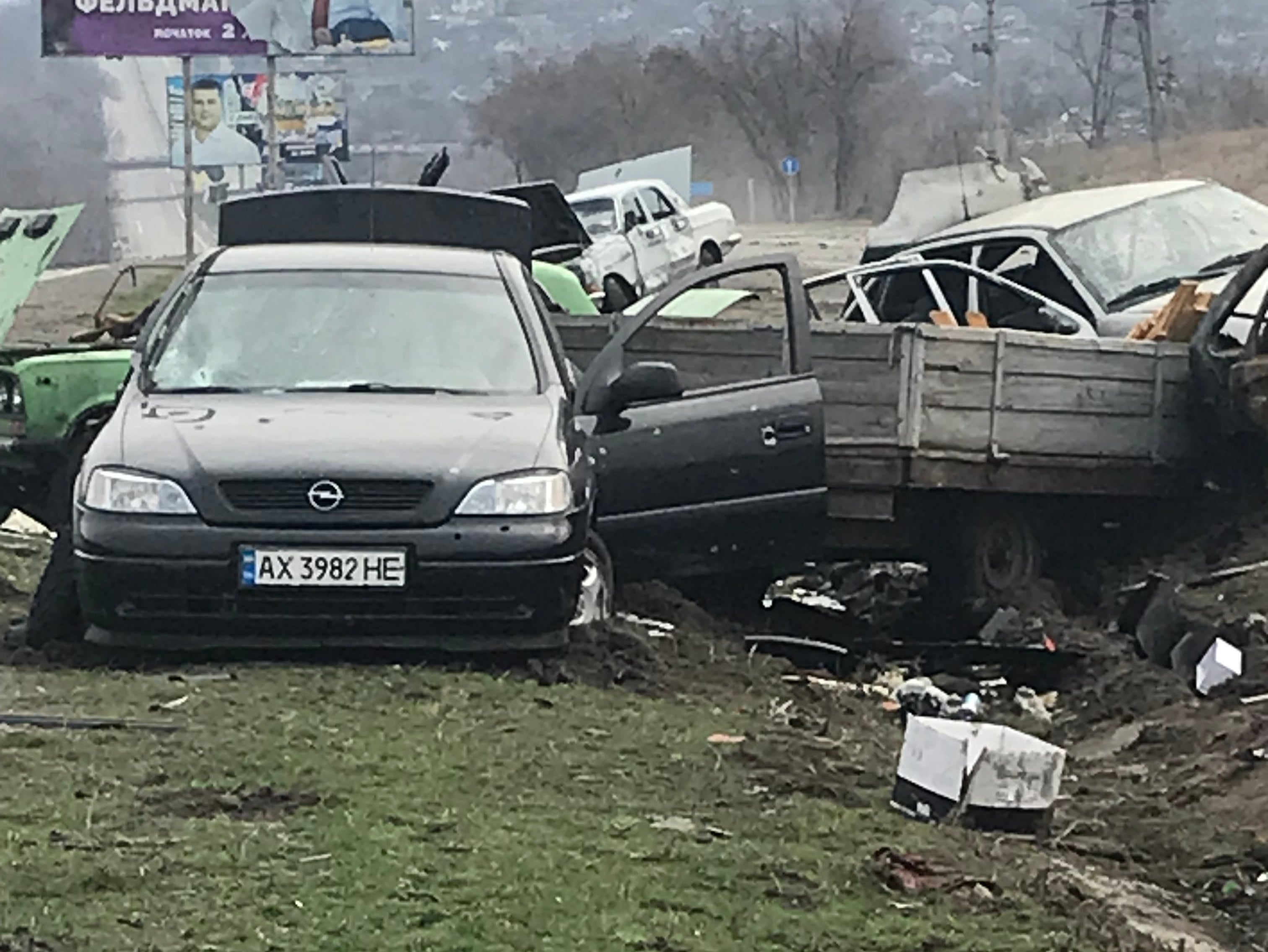 Cars hit on the road outside the village of Mala Rohan