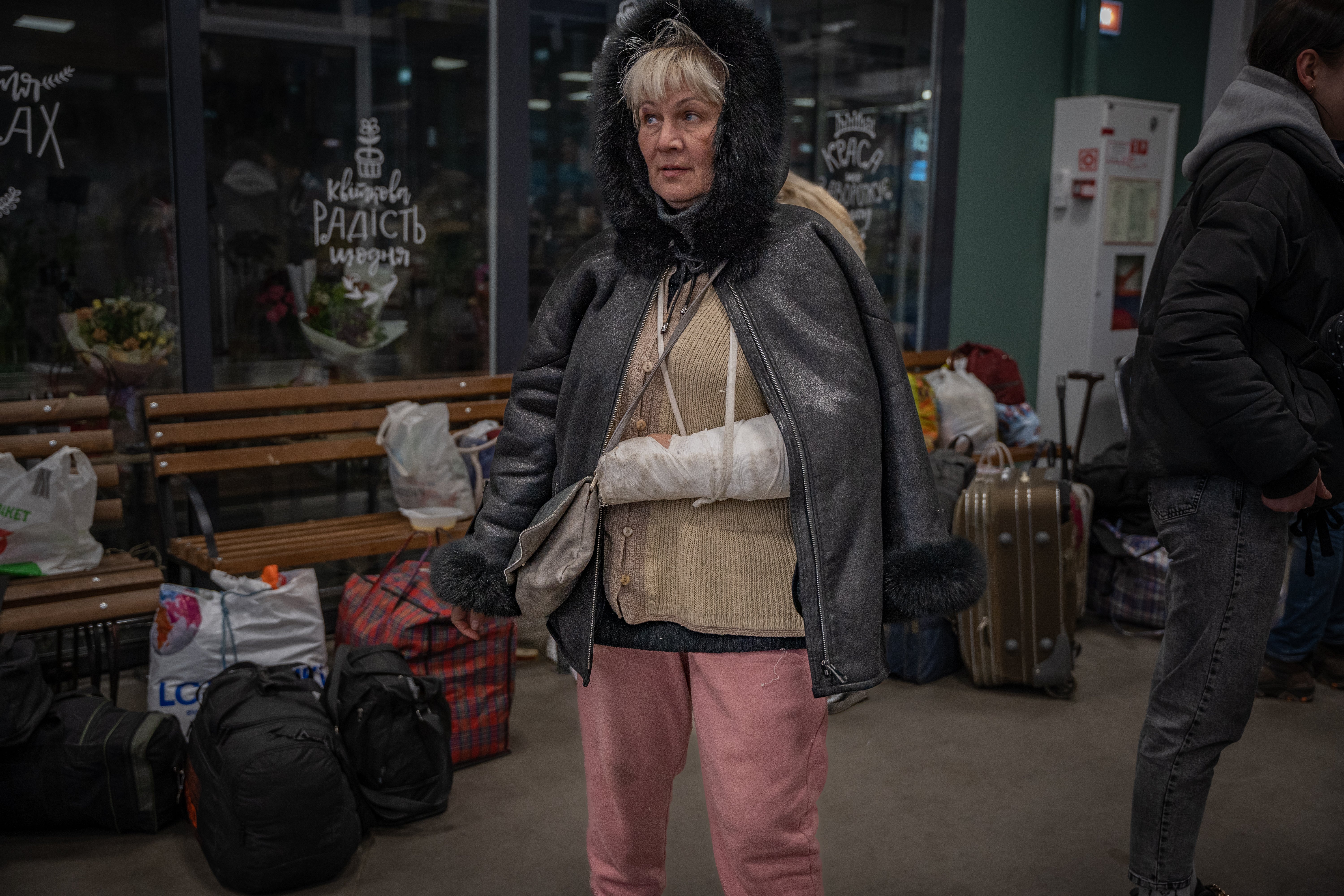 A woman wounded in Mariupol arrives in a volunteer-run reception centre in Zaporizhzhia