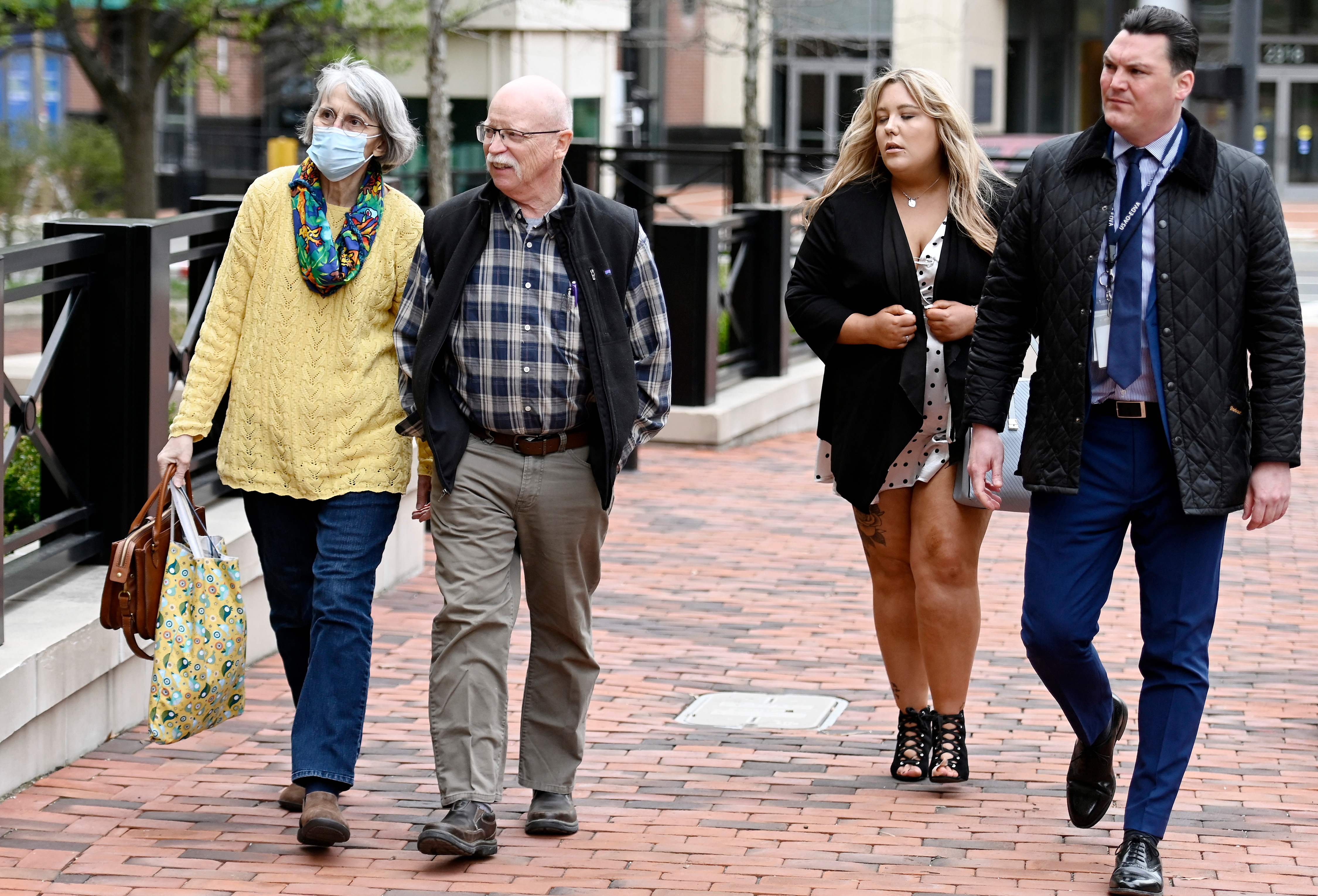 Paula and Ed Kassig, left, parents of Peter Kassig, and Bethany Haines, second right, daughter of David Haines, at the Alexandria federal court house as the trial begins