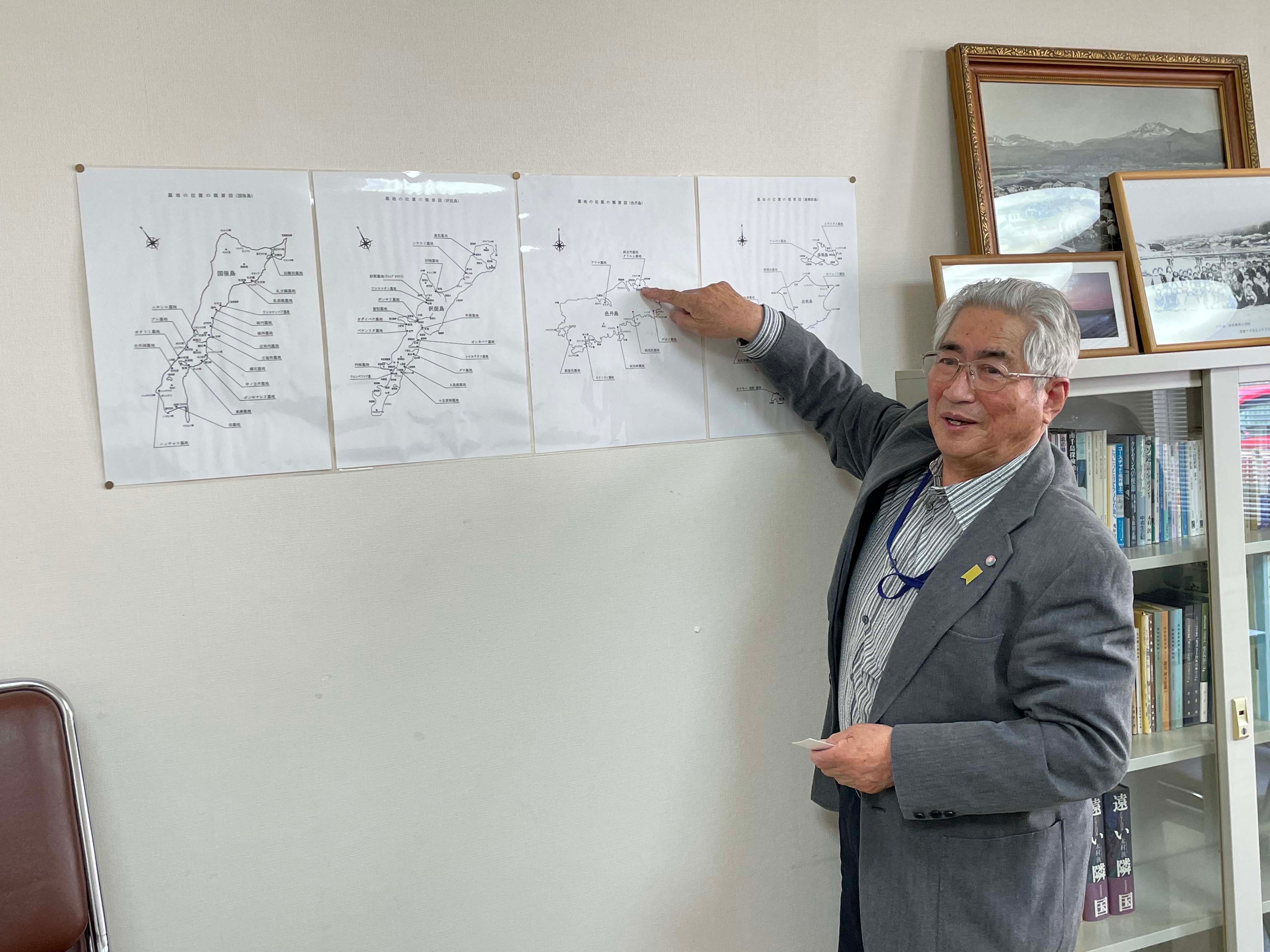 Hiroshi Tokunu, 88, points to the part of Shikotan island where he lived until he was 13