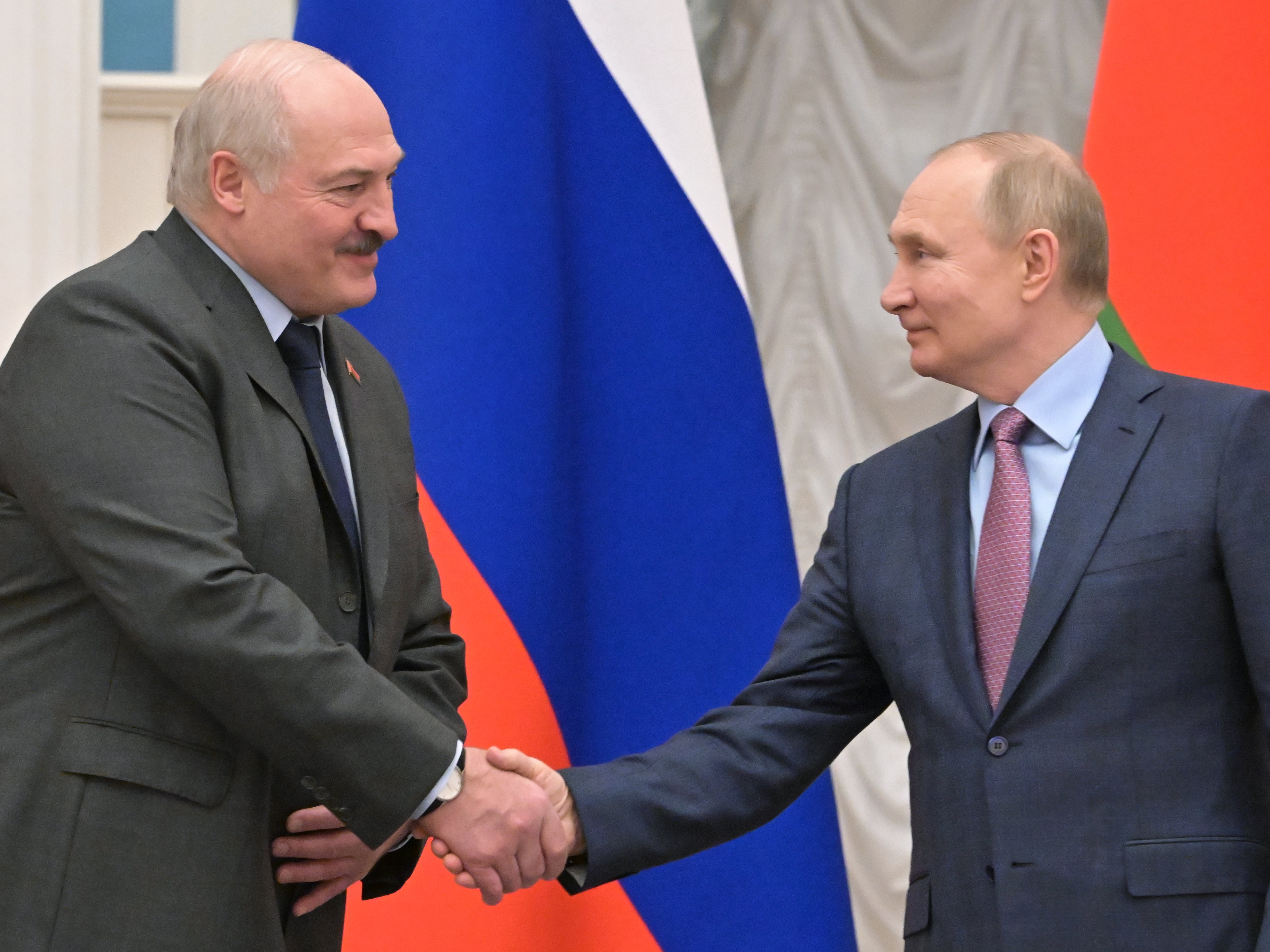 Alexander Lukashenko and Vladimir Putin shake hands during a joint press conference at the Kremlin, 18 February 2022