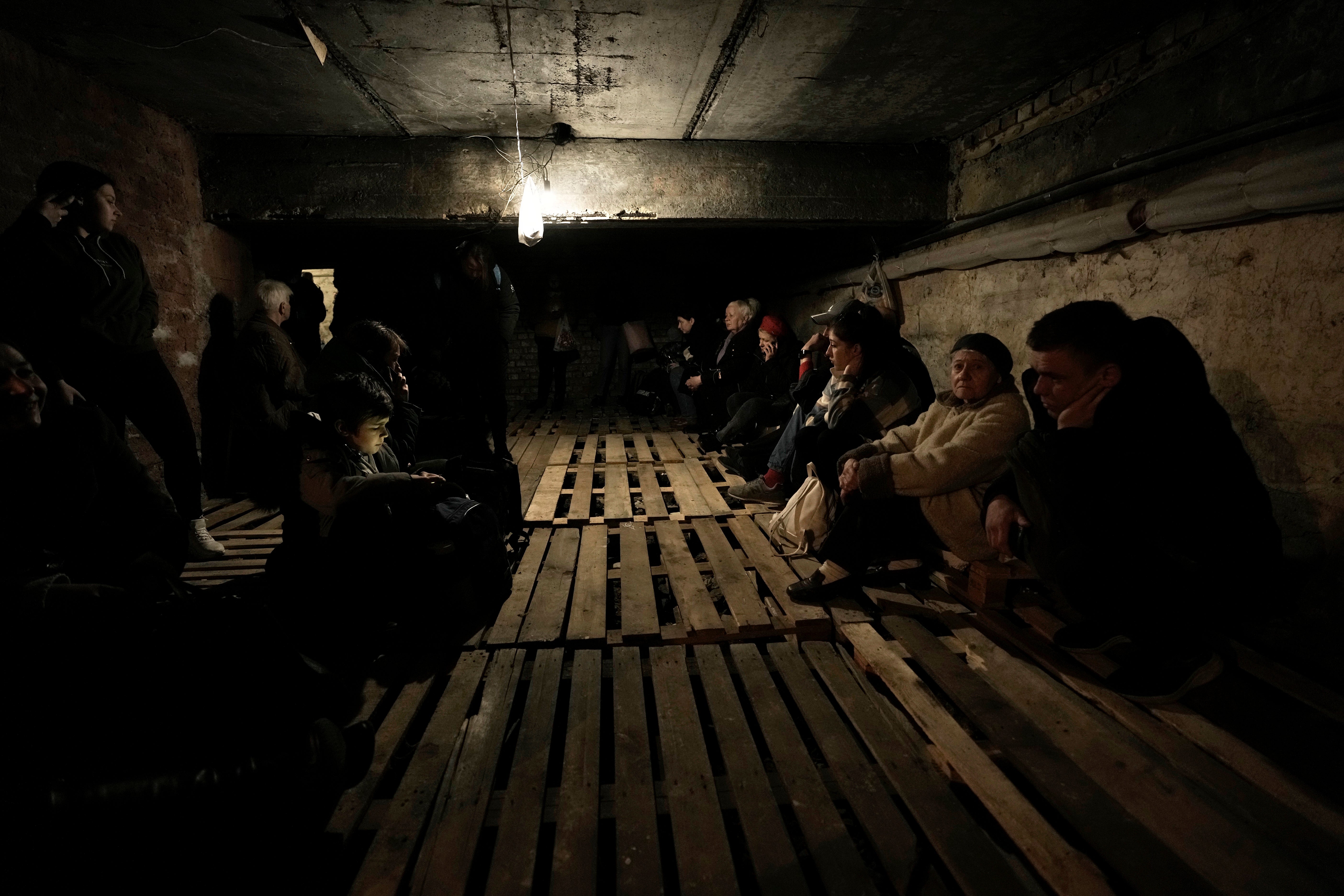 People shelter underground following explosions in Lviv, western Ukraine