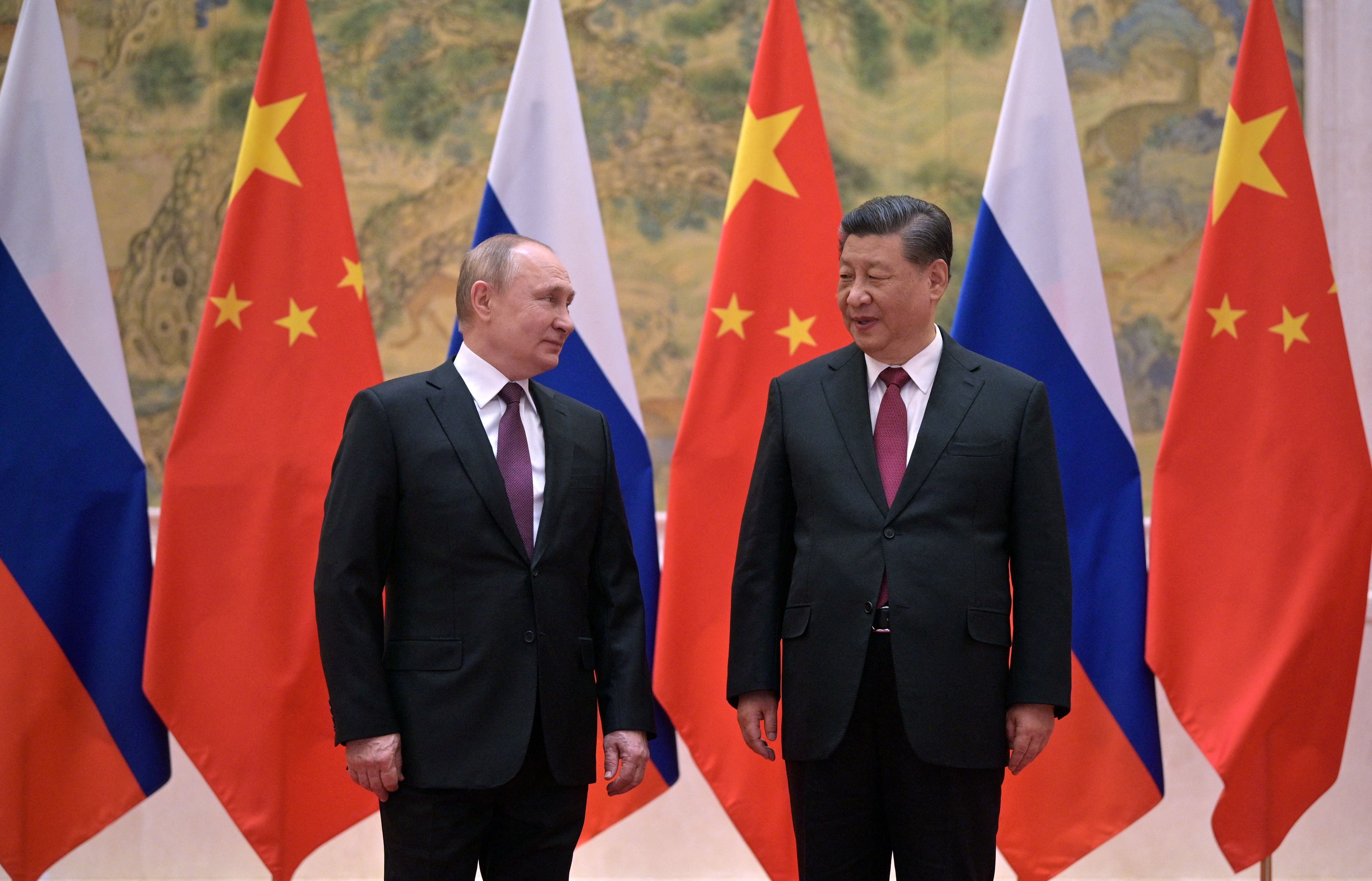 Putin and Xi Jinping pose during their meeting in Beijing in March