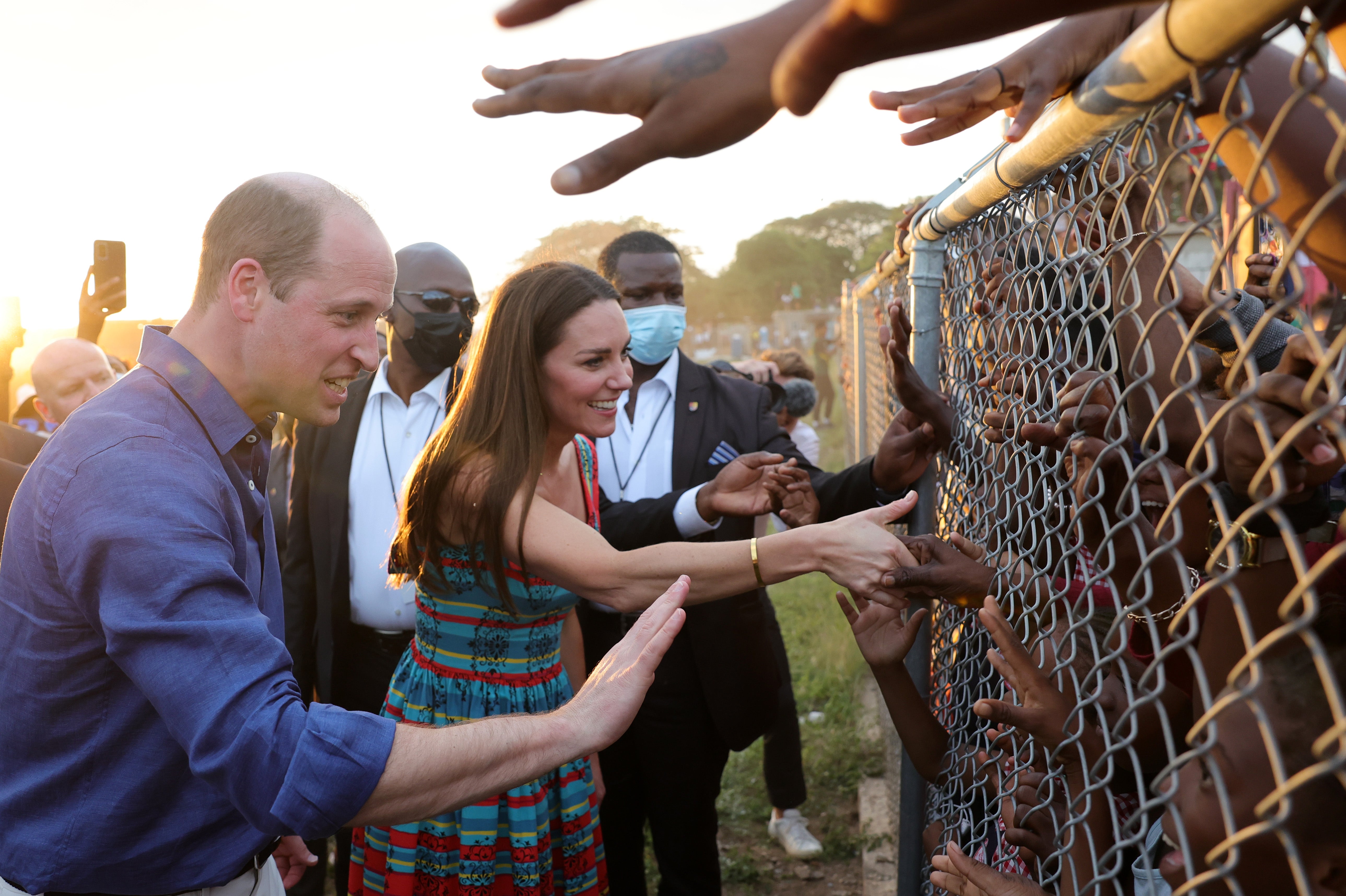 The Duke and Duchess of Cambridge were widely criticsed over this photo, as they shake hands with children behind fences during a visit to Trench Town