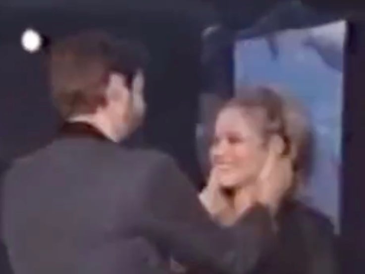 Jim Carrey forcibly pulls Alicia Silverstone into a kiss while accepting trophy at 1997 awards show