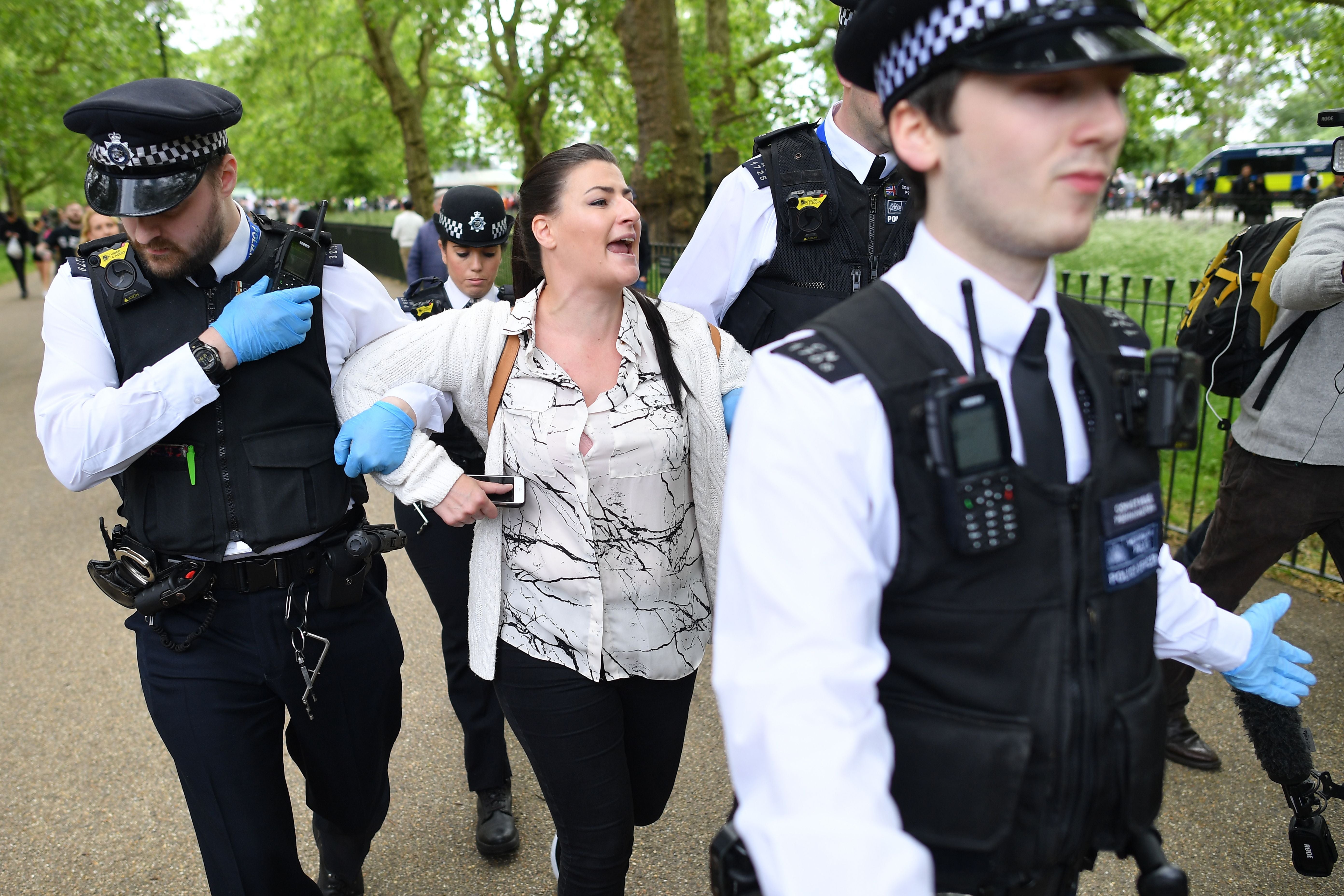 A woman is arrested at an anti-lockdown protest in Hyde Park