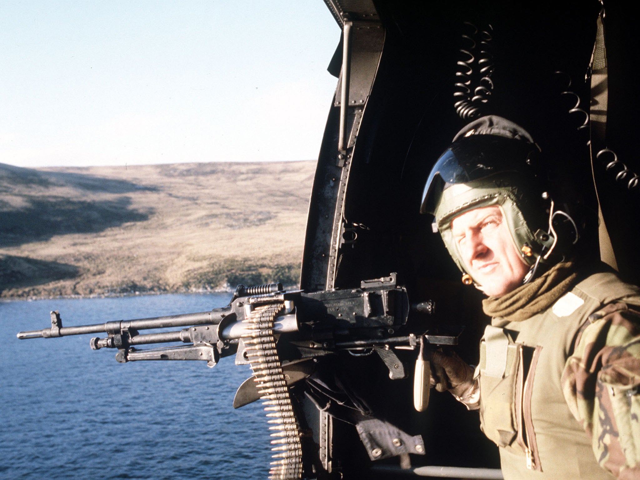 A British soldier on a helicopter patrol over East Falkland during the war