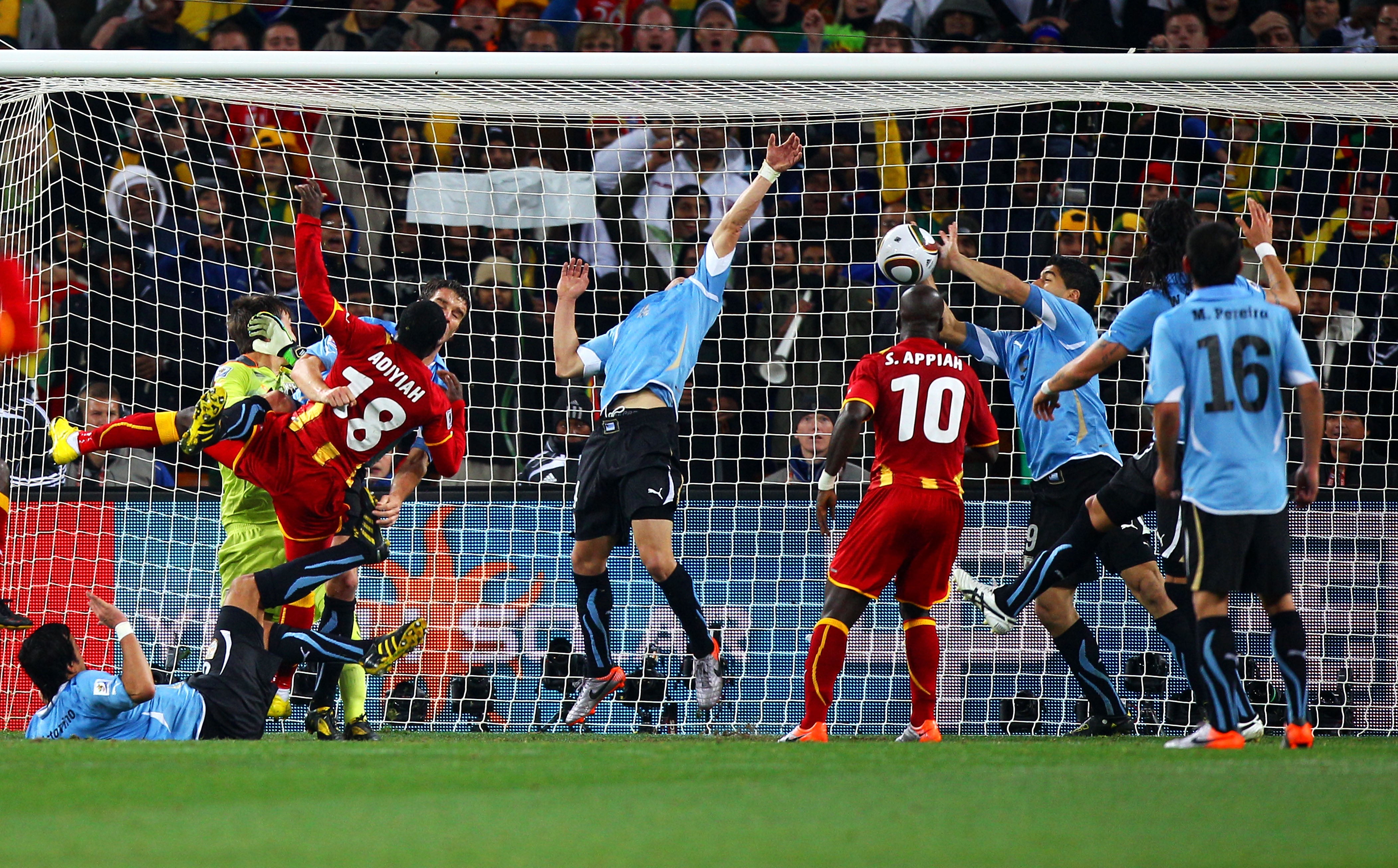 Luis Suarez of Uruguay handles the ball on the goal line, for which he is sent off