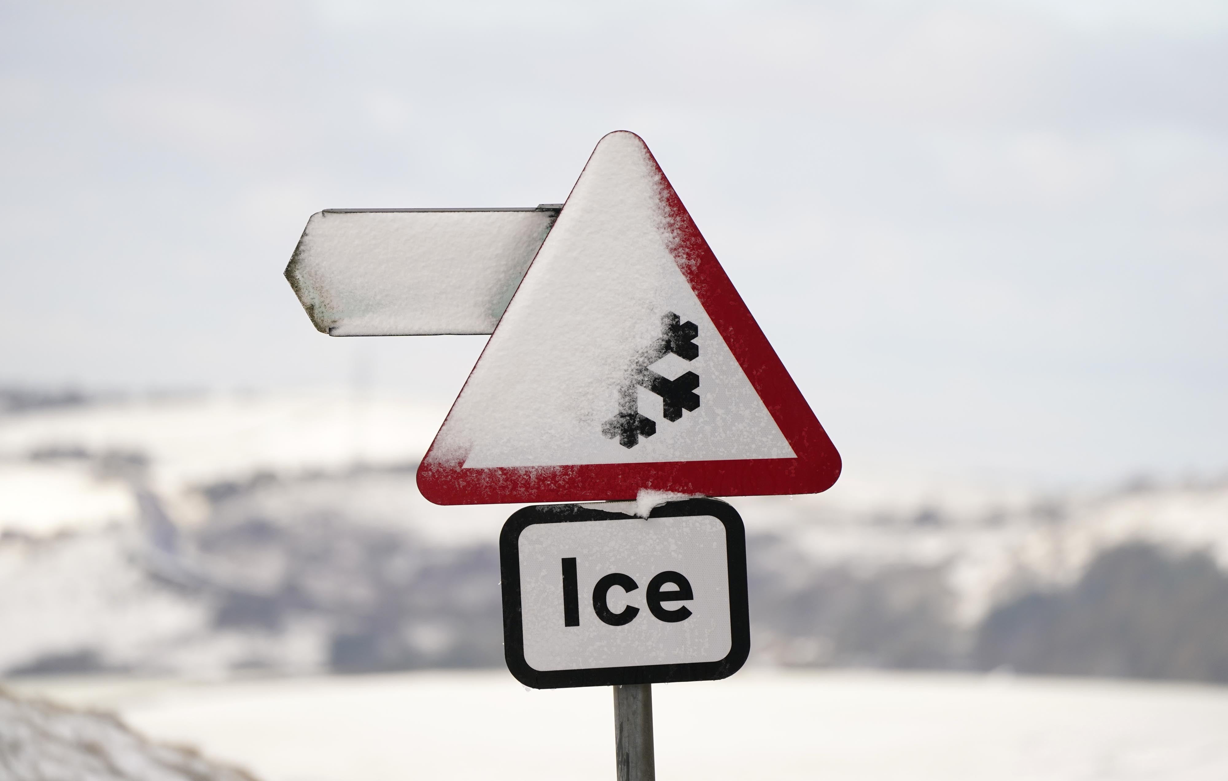 A snowy sign in Saddleworth near Oldham (PA)