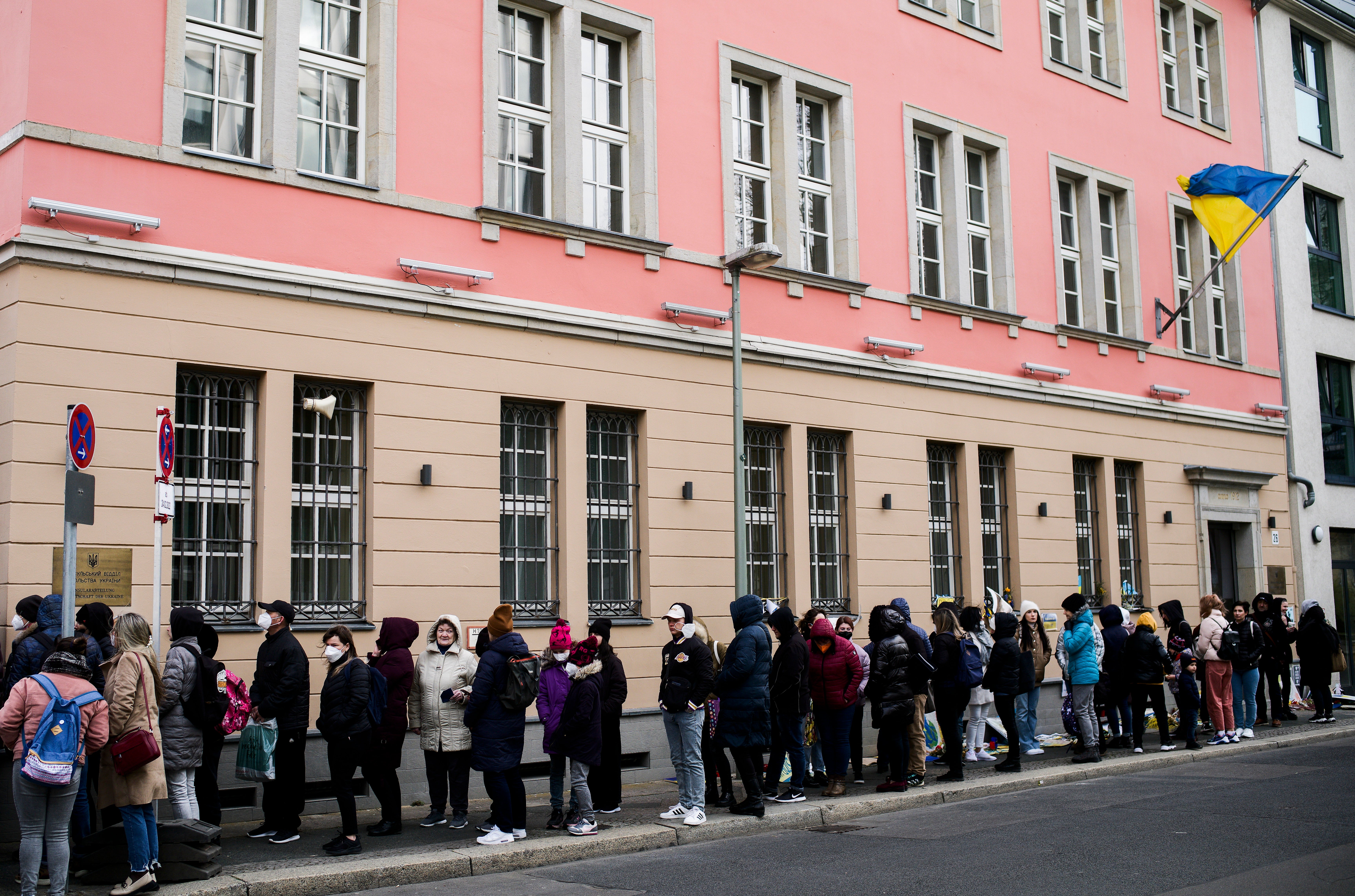 People from the Ukraine, most of them refugees fleeing the war, wait in front of the consular department of the Ukrainian embassy in Berlin