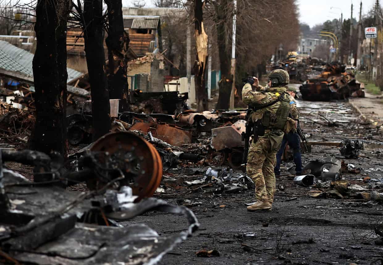 A soldier surveys the destruction left in Bucha