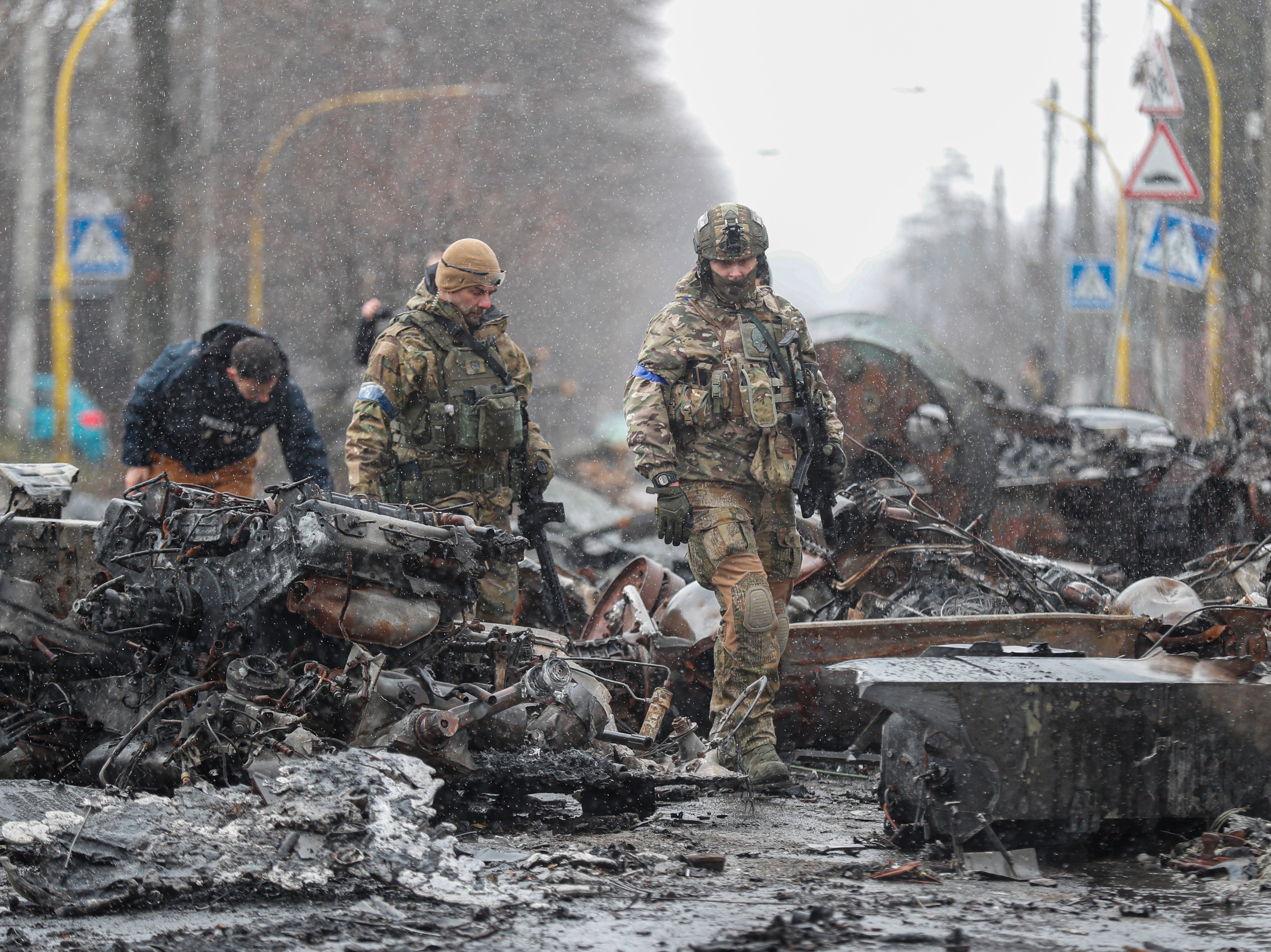 Ukrainian Soldiers inspect destroyed Russian military machinery in the city of Bucha