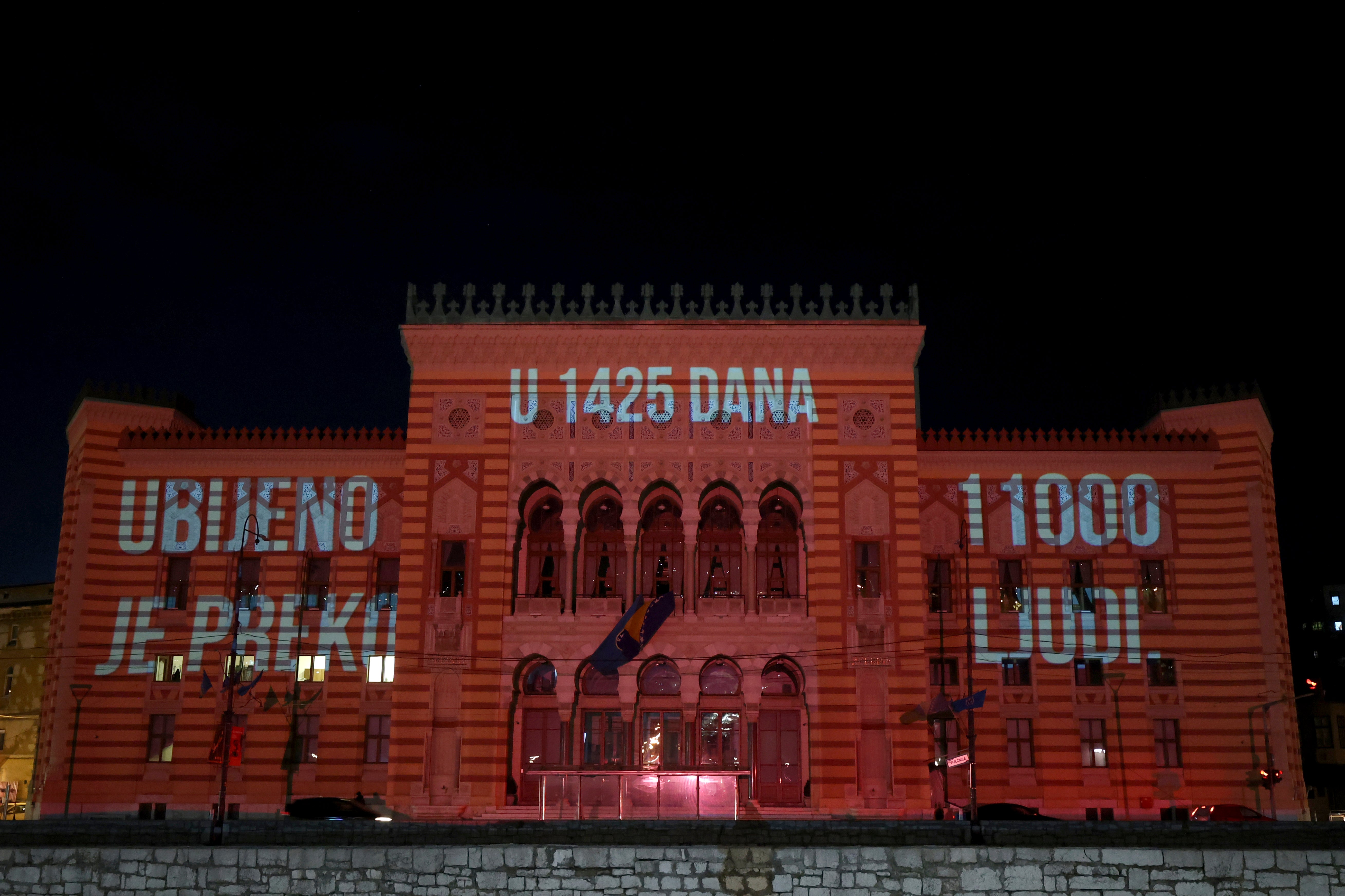 Words reading ‘in 1425 days over 11000 was killed’ are displayed on the city hall in Sarajevo, Bosnia, Monday, April 4, 2022