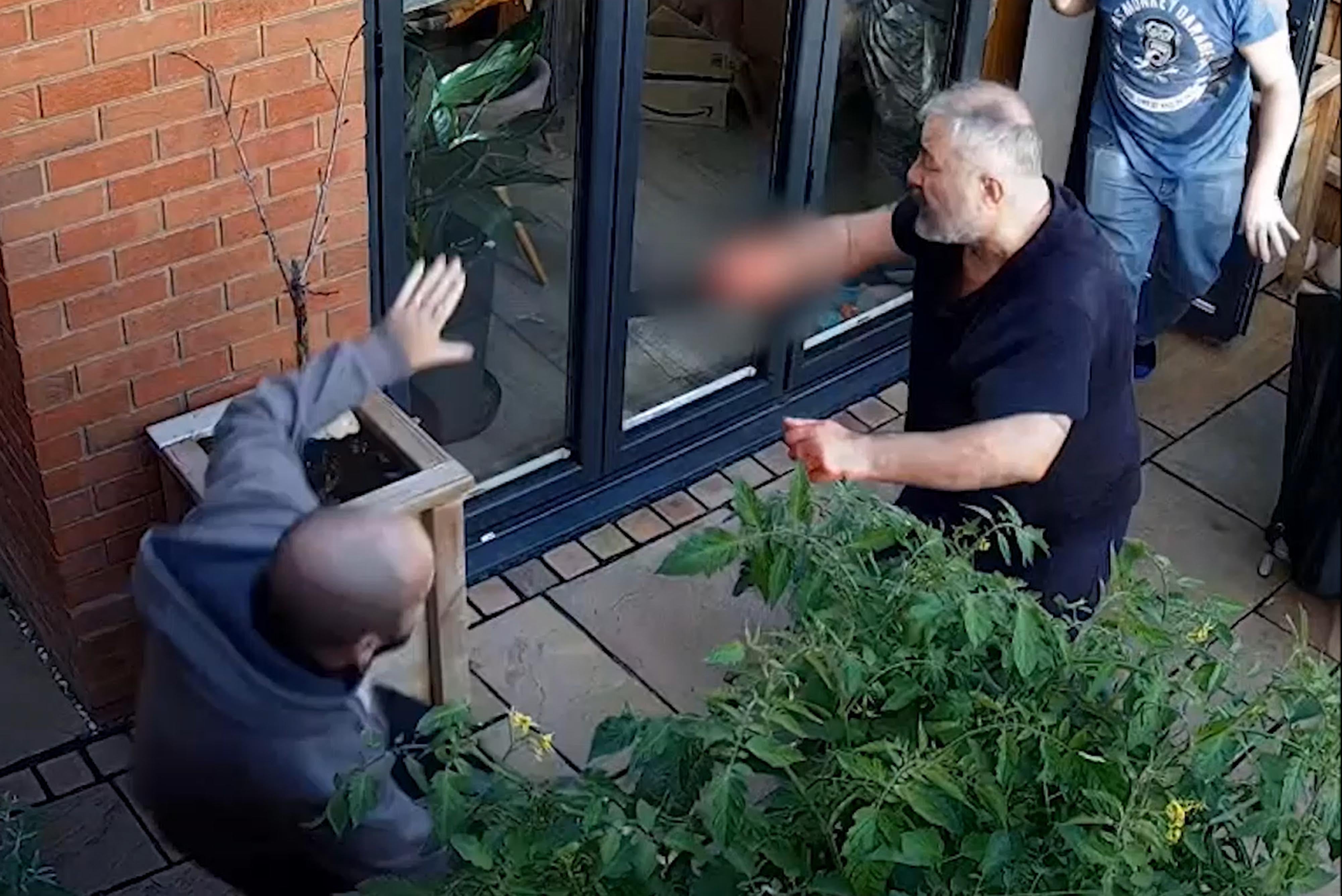 Can Arslan being confronted by off-duty officer Sergeant Steve Wilkinson, left, outside the home of Peter Marsden (Gloucestershire Police/PA)