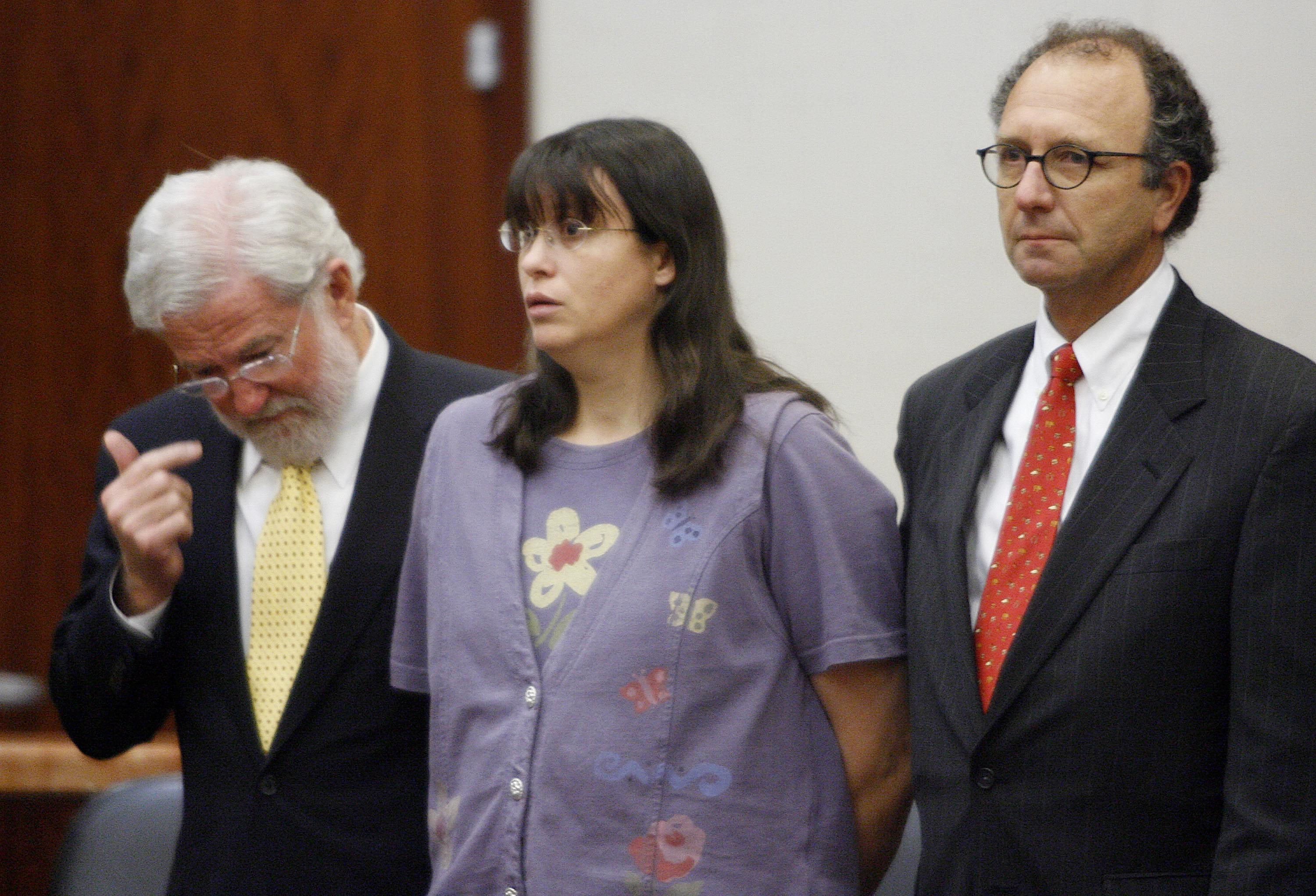 Andrea Yates (C) listens with her attorneys, George Parnham (L) and Wendell Odom (R)