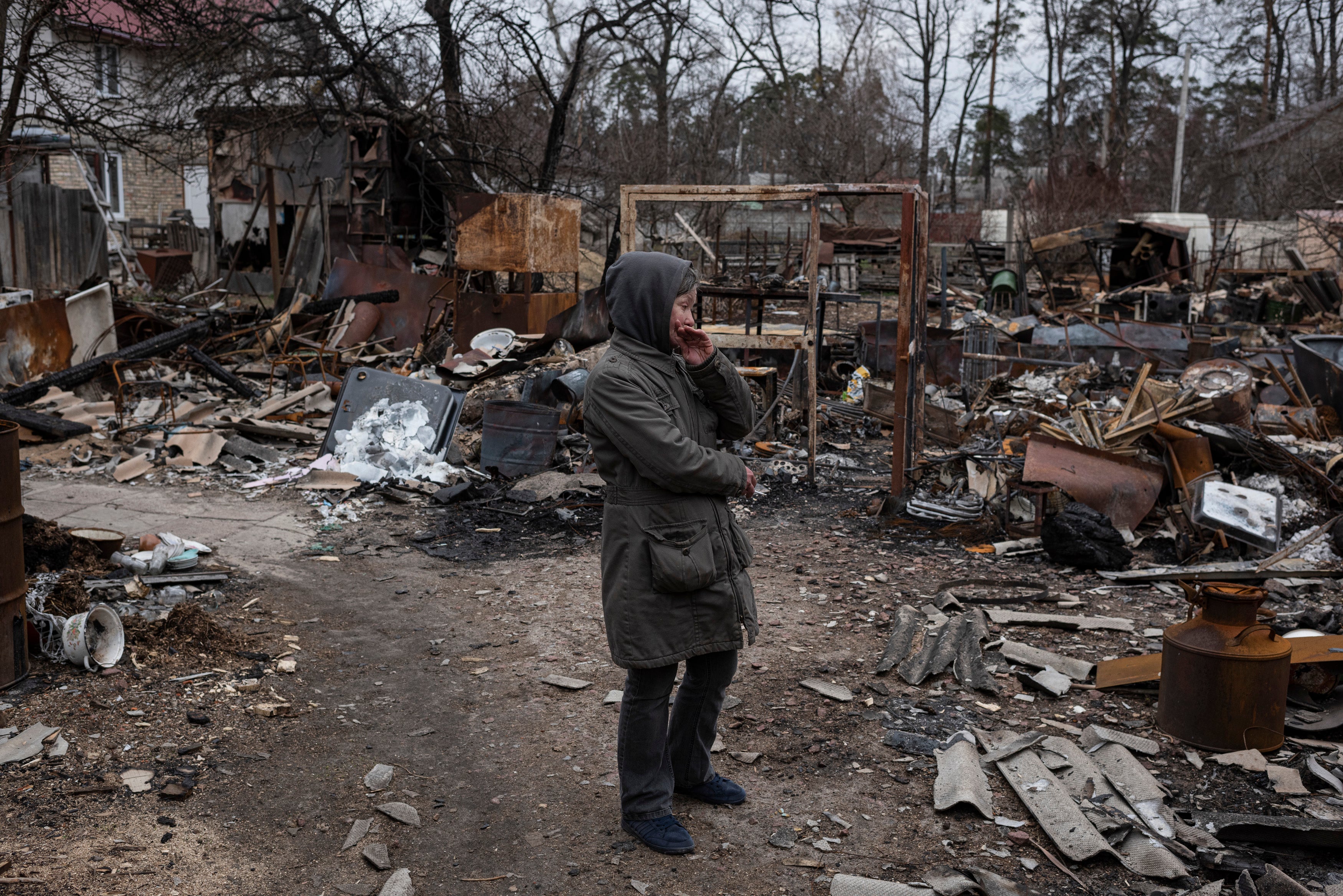 Olia, 53, stands next to destroyed constructions in her courtyard, on April 5, 2022 in Bucha