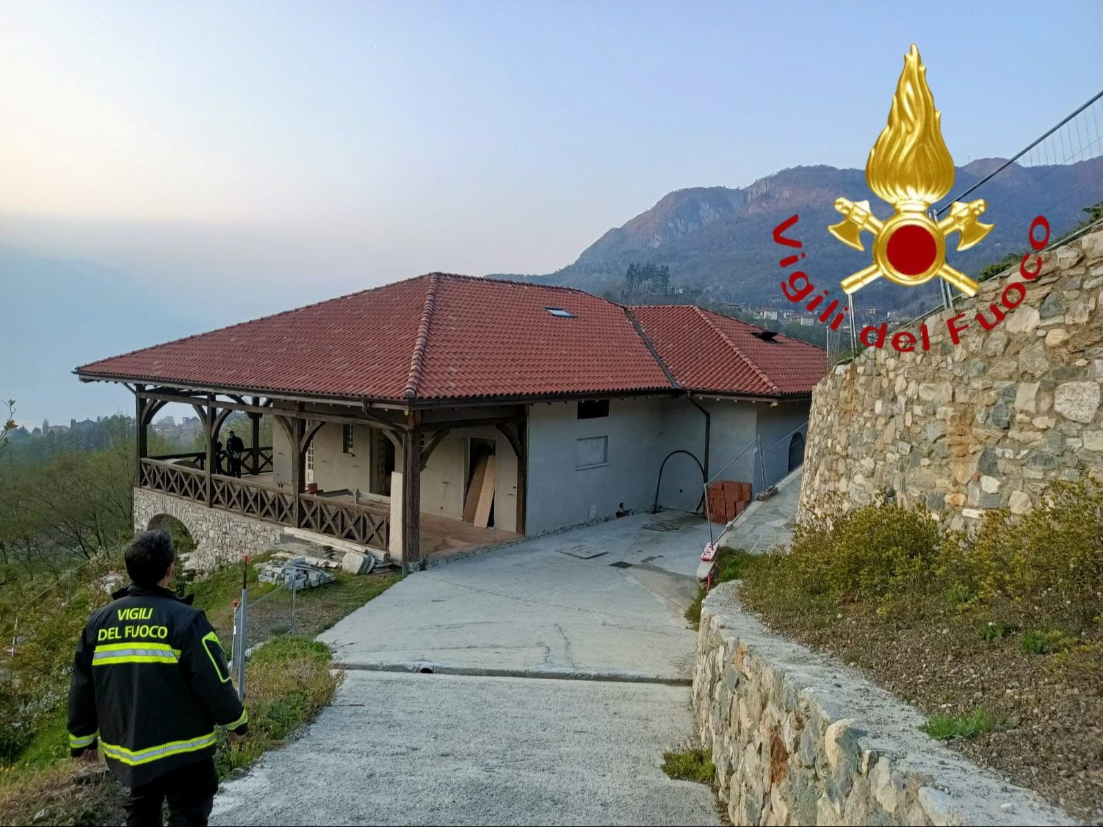 A firefighter walks by the Menaggio villa owned by Vladimir Soloviev on Wednesday