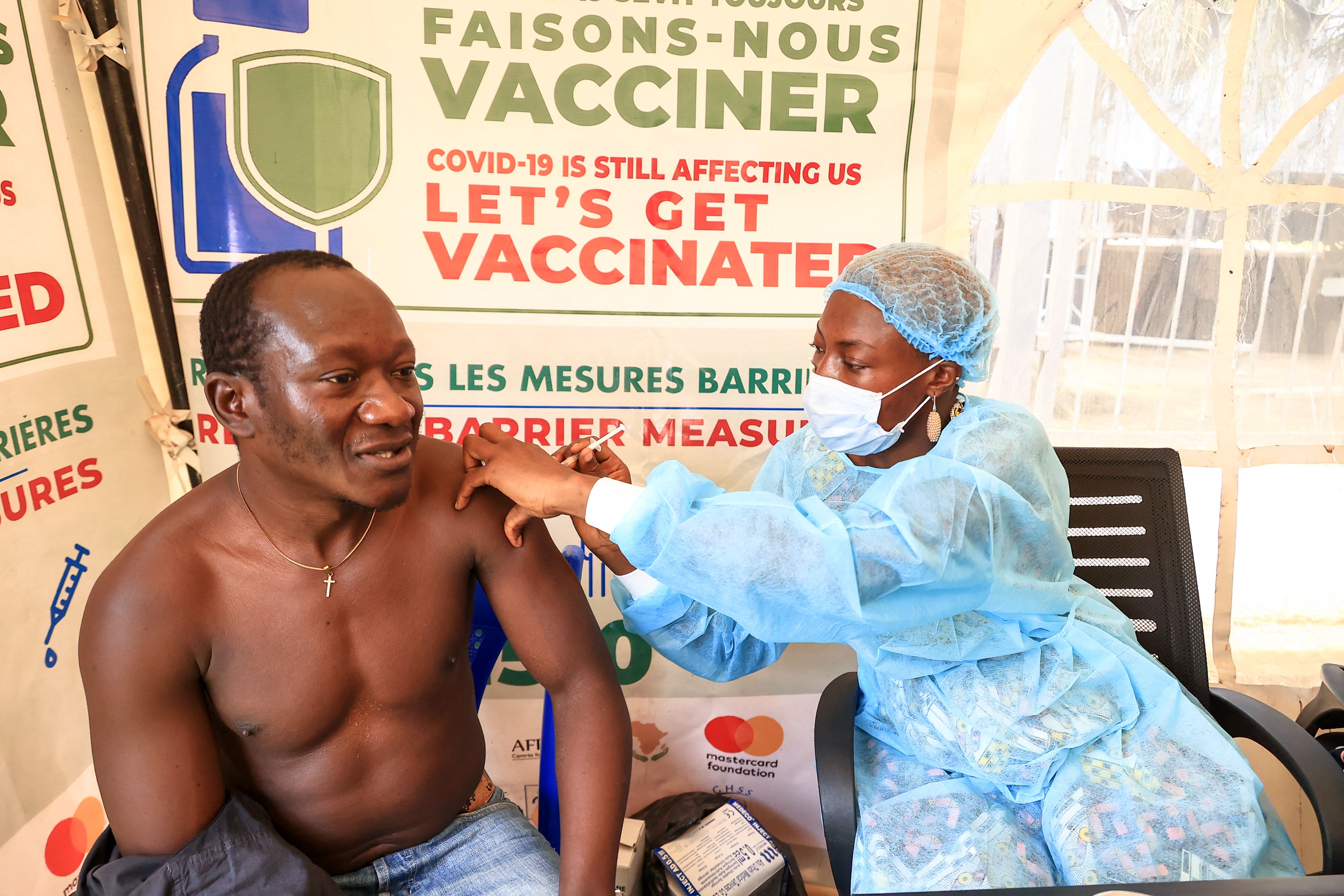 A nurse prepares a Covid-19 vaccine to a person at the Palais des Sports vaccination centre in Yaounde, Cameroon. Only around 3 percent of the population of the country have been fully vaccinated, according to Reuters.