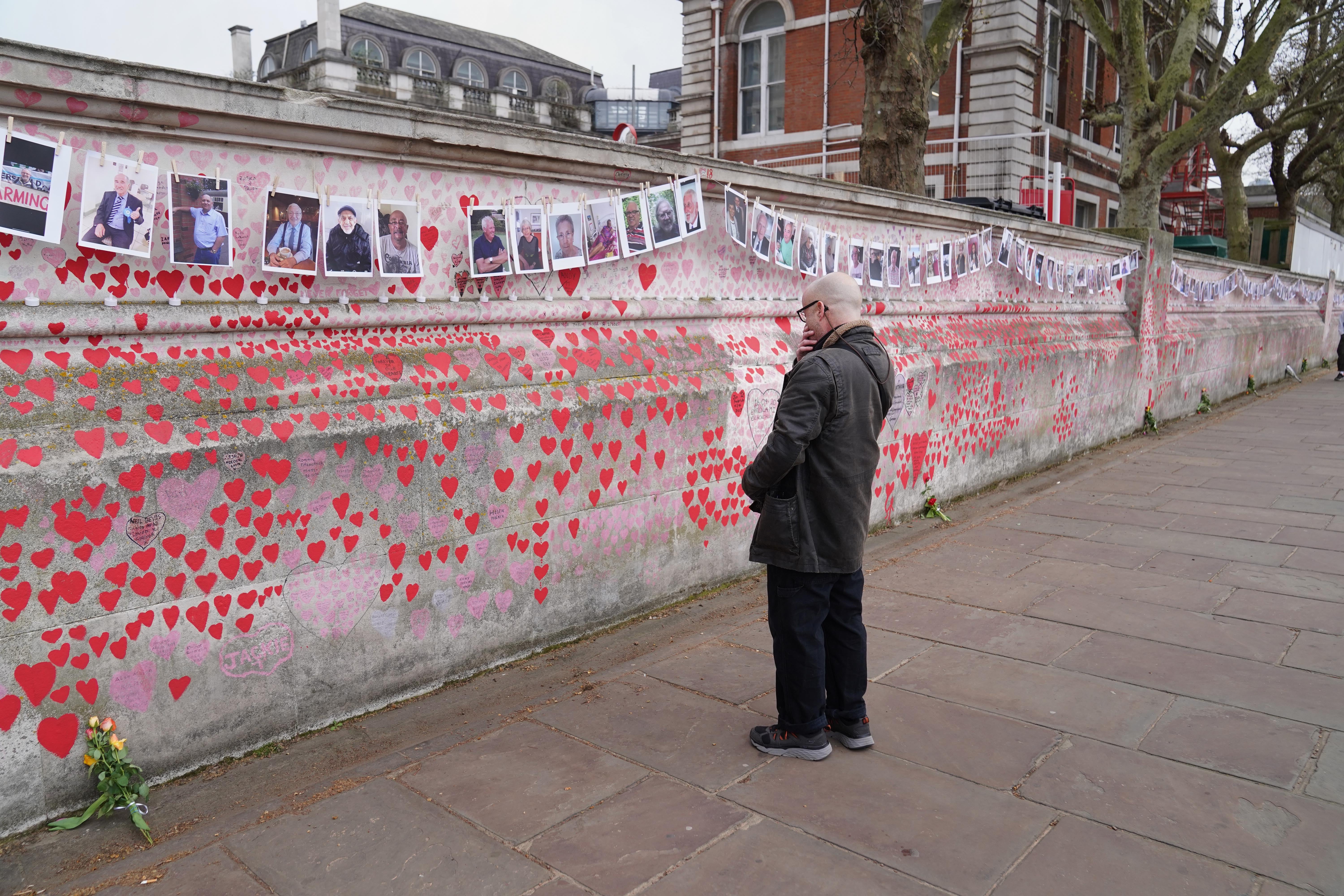 A man looks at the Covid memorial wall in London