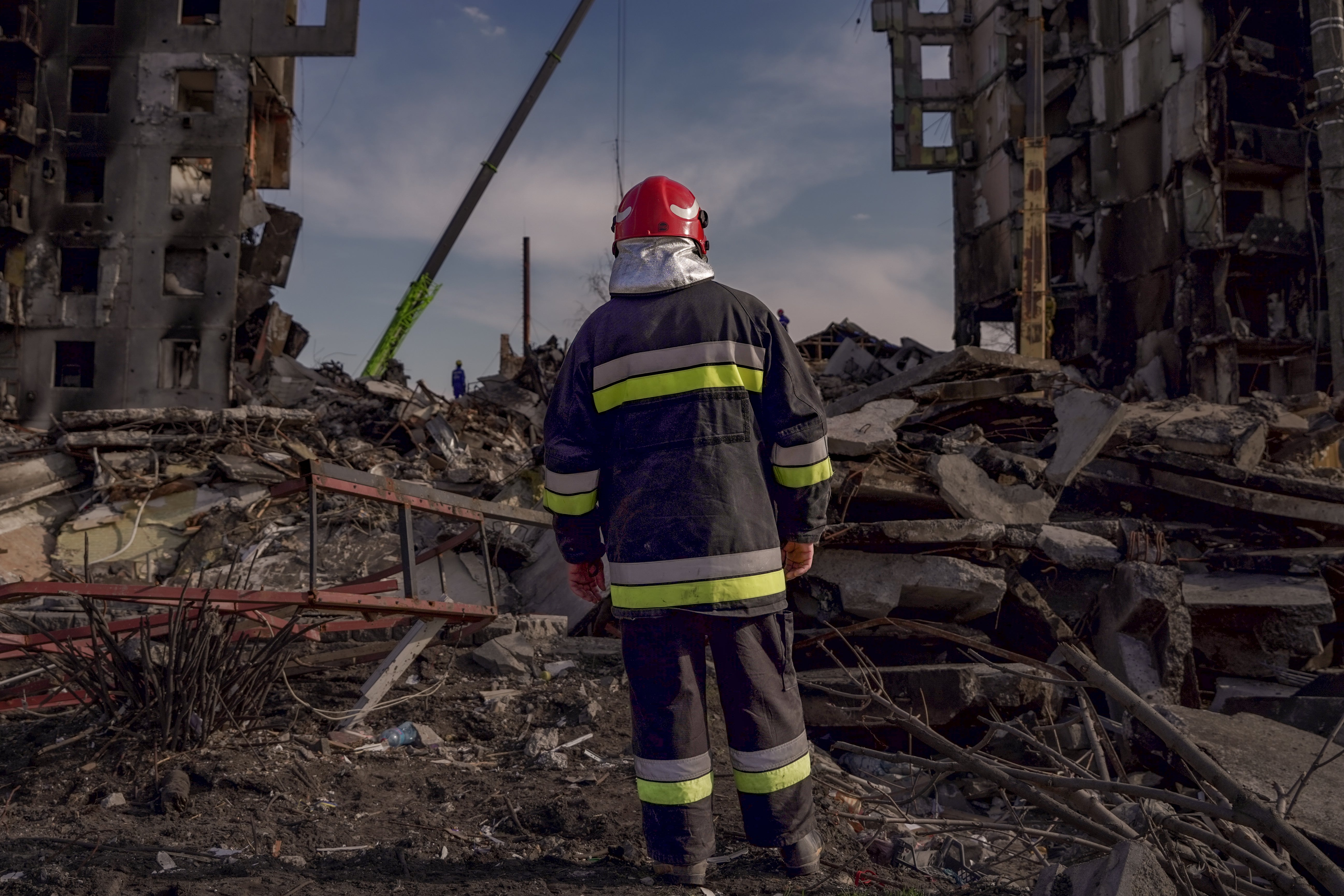 Firefighters dig for bodies in the rubble of Borodyanka