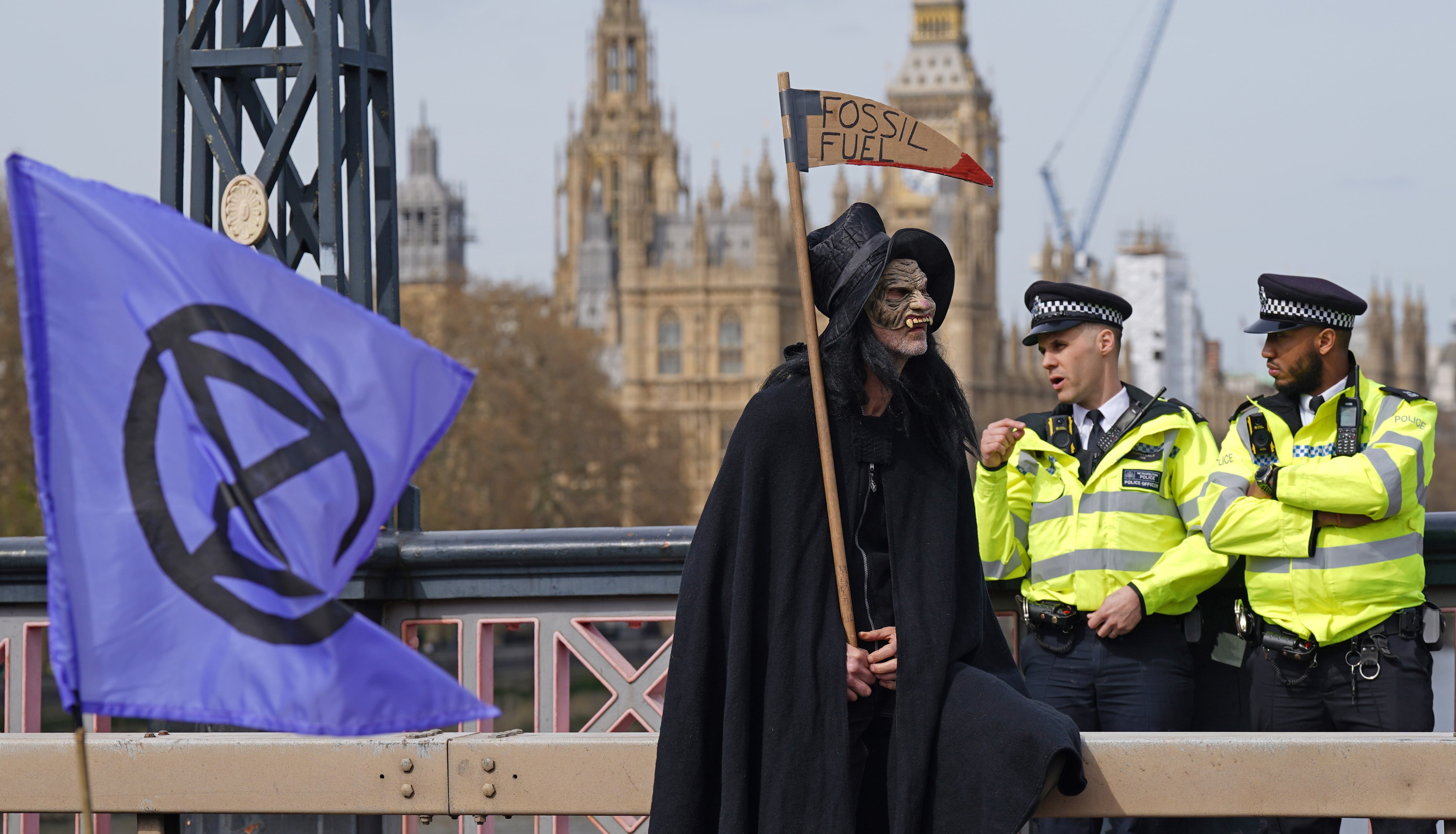 Activists from Extinction Rebellion blocking Lambeth Bridge in central London (Yui Mok/PA)