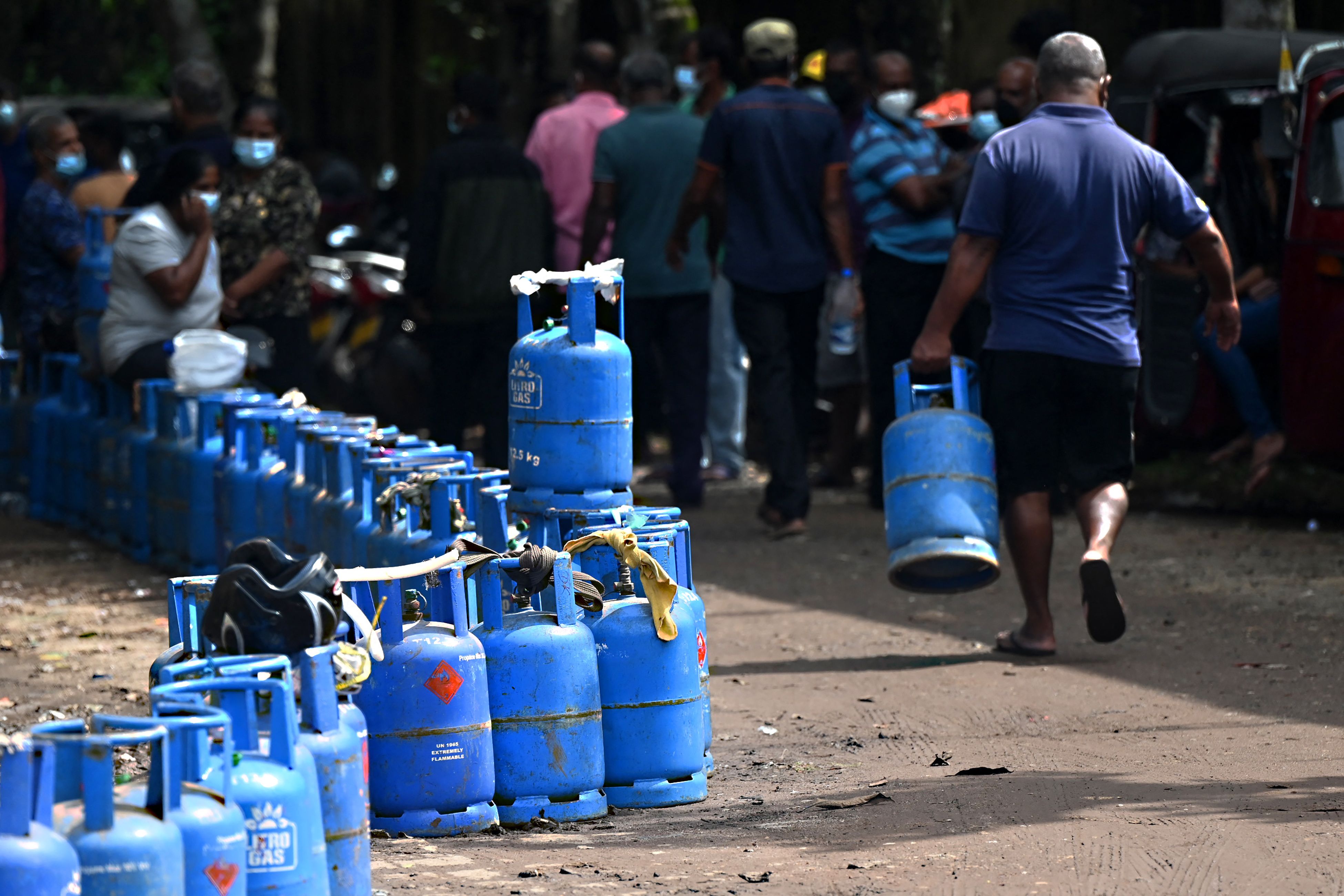 People queue to buy Liquefied Petroleum Gas (LPG) cylinders in Colombo on 11 April 2022