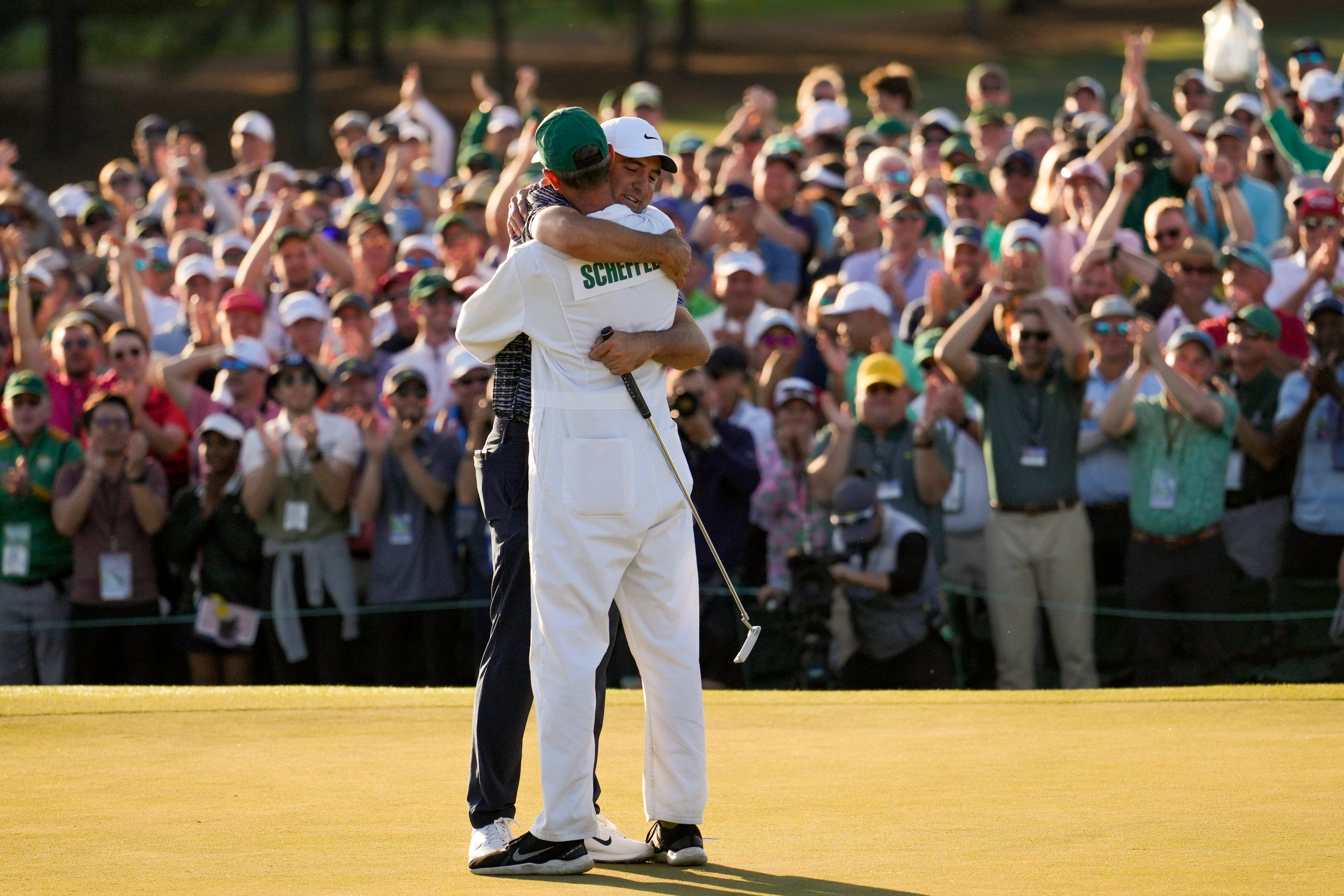 Scottie Scheffler hugs his caddie Ted Scott after winning the 86th Masters (Jae C. Hong/AP)