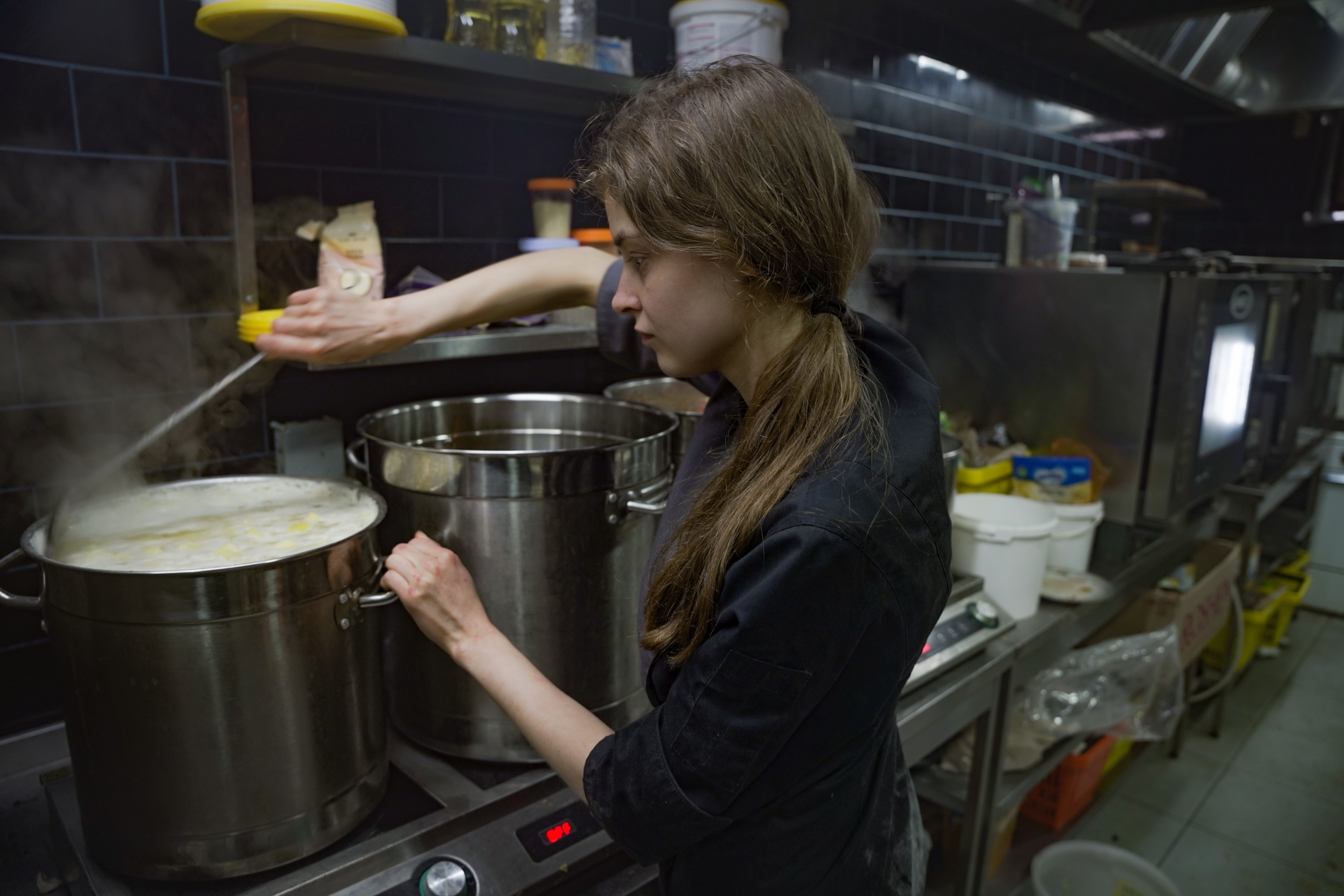 Volunteers at Sparkle of Goodness make food for the city