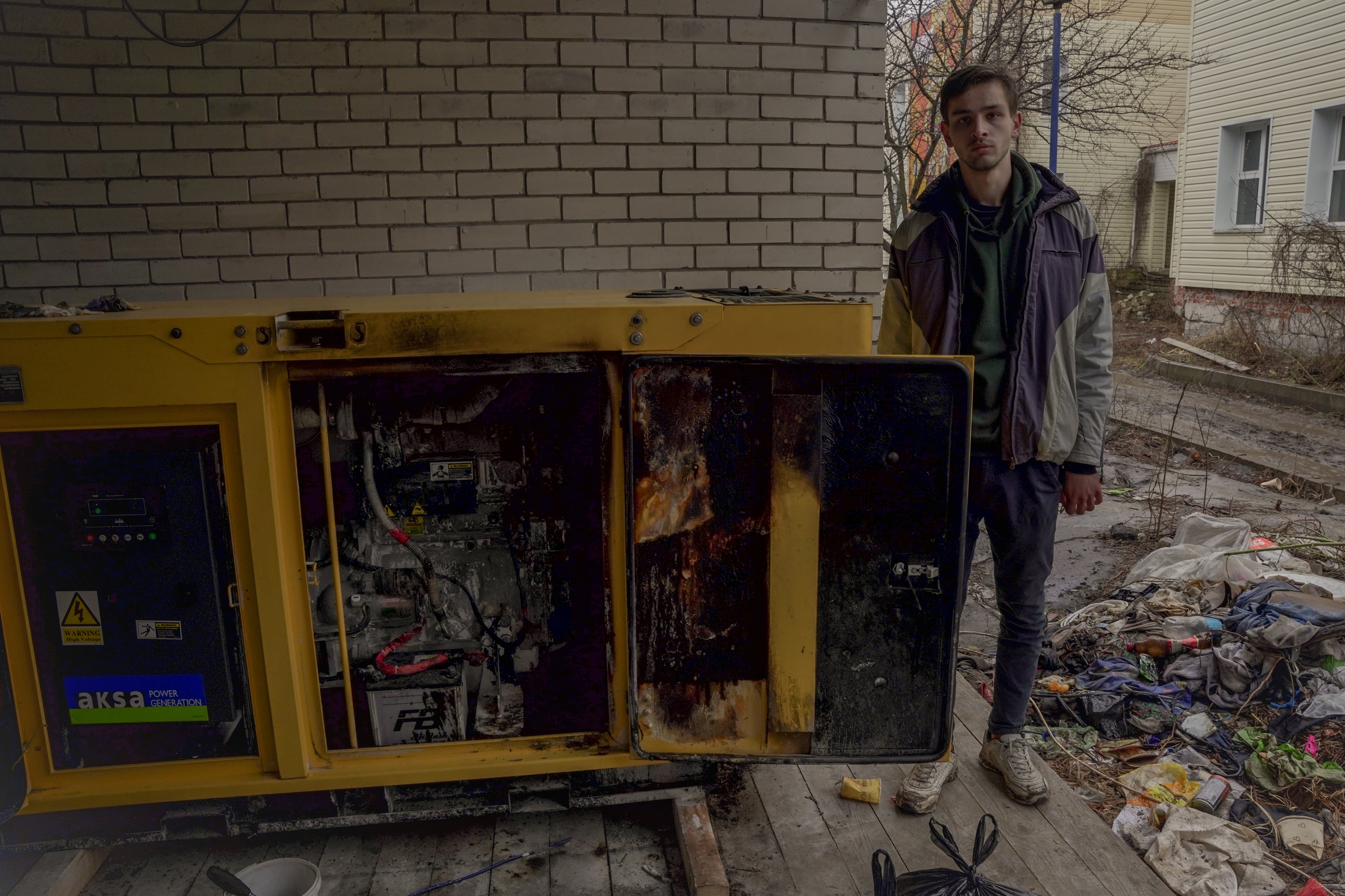 Igor stands by one of the partially bombed generators the volunteers salvaged and got working again