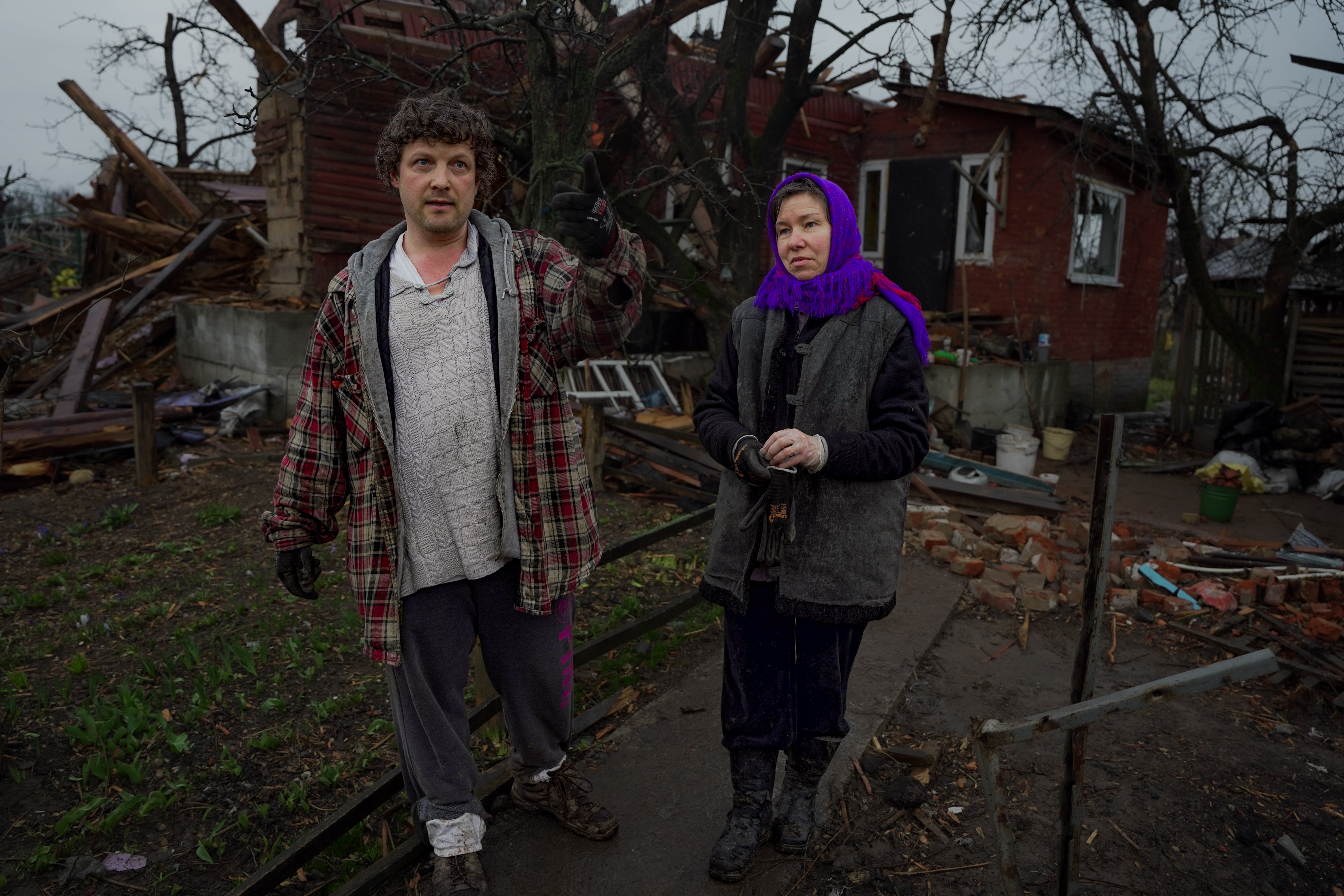 Andrei and his wife Svetlana survey the damage to their home