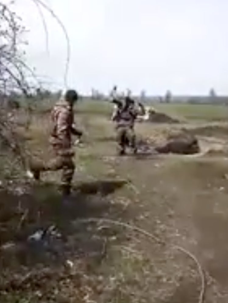 A Ukrainian solider rushes to the side of his fellow serviceman after he successfully took down a Russian drone amid cheers