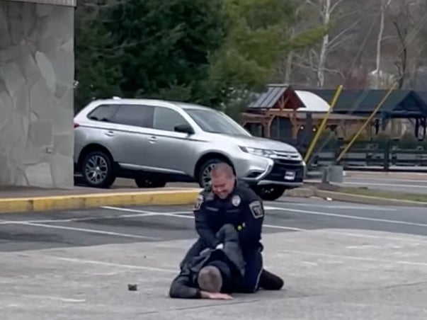 Richard Glazewski, 54, of Pennsylvania, is apprehended in a gas station parking lot by a police officer after placing stickers depicting Joe Biden alongside the message ‘I did that!’ on gas pumps. The stickers are a protest against high gas prices, which some conservatives blame on Mr Biden and the Democrats.