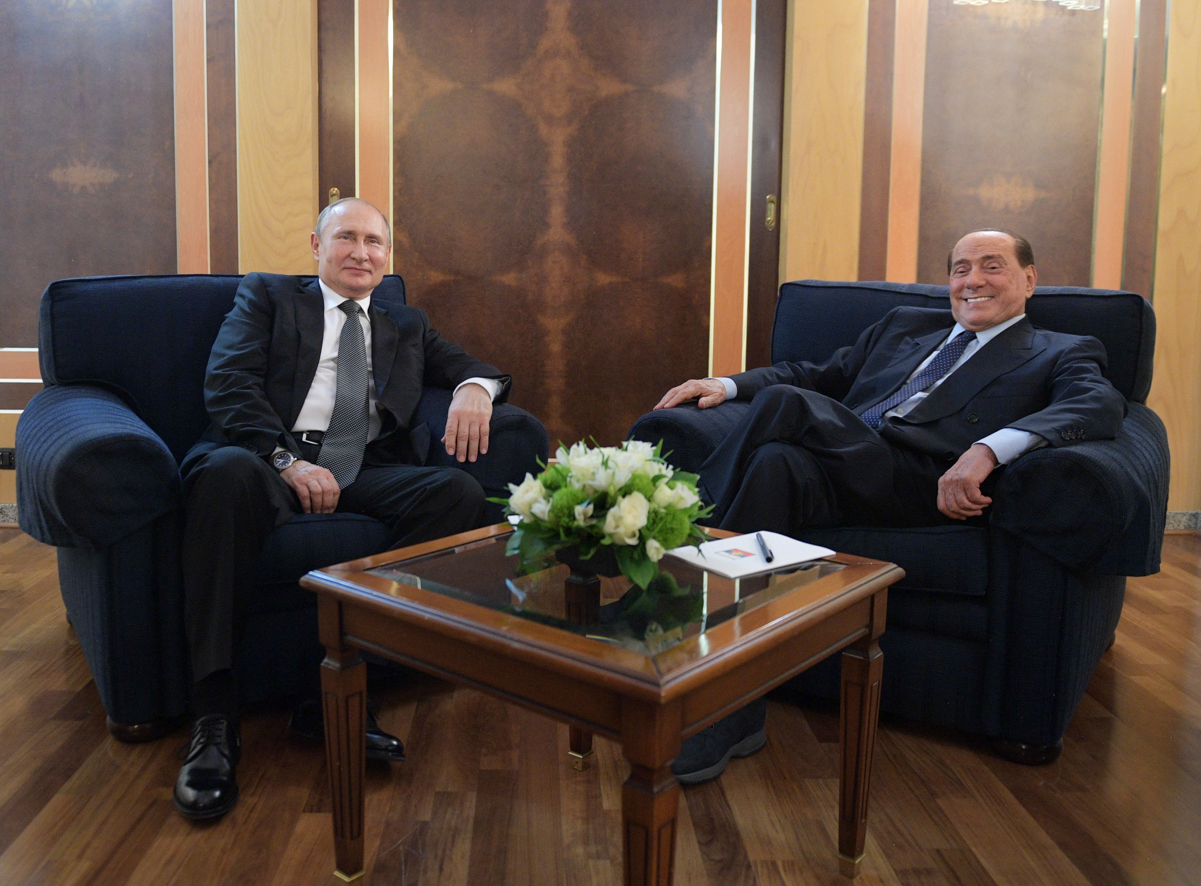 Putin meets with Berlusconi at an airport in Rome, 2019