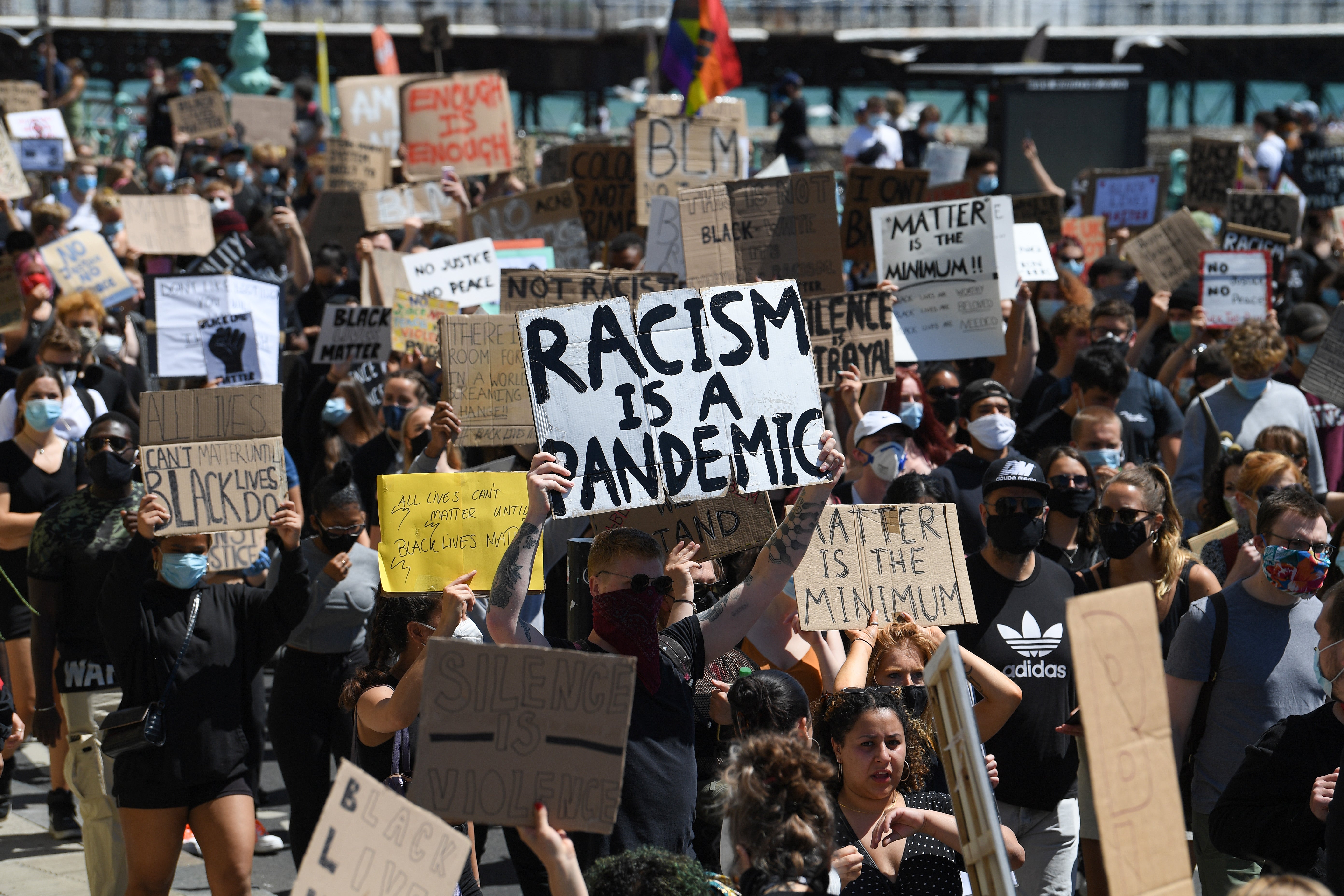 Thousands of protestors hold signs at a Black Live Matters rally on June 13, 2020 in Brighton