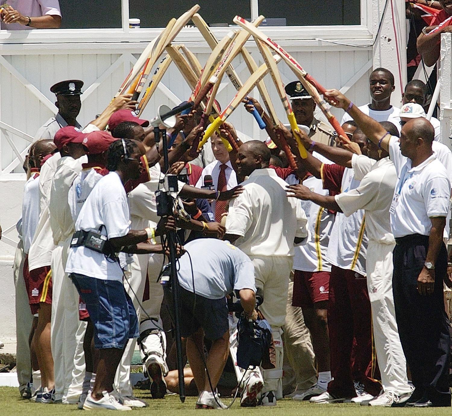 Brian Lara is given a guard of honour after his record-breaking feat (Rebecca Naden/PA)