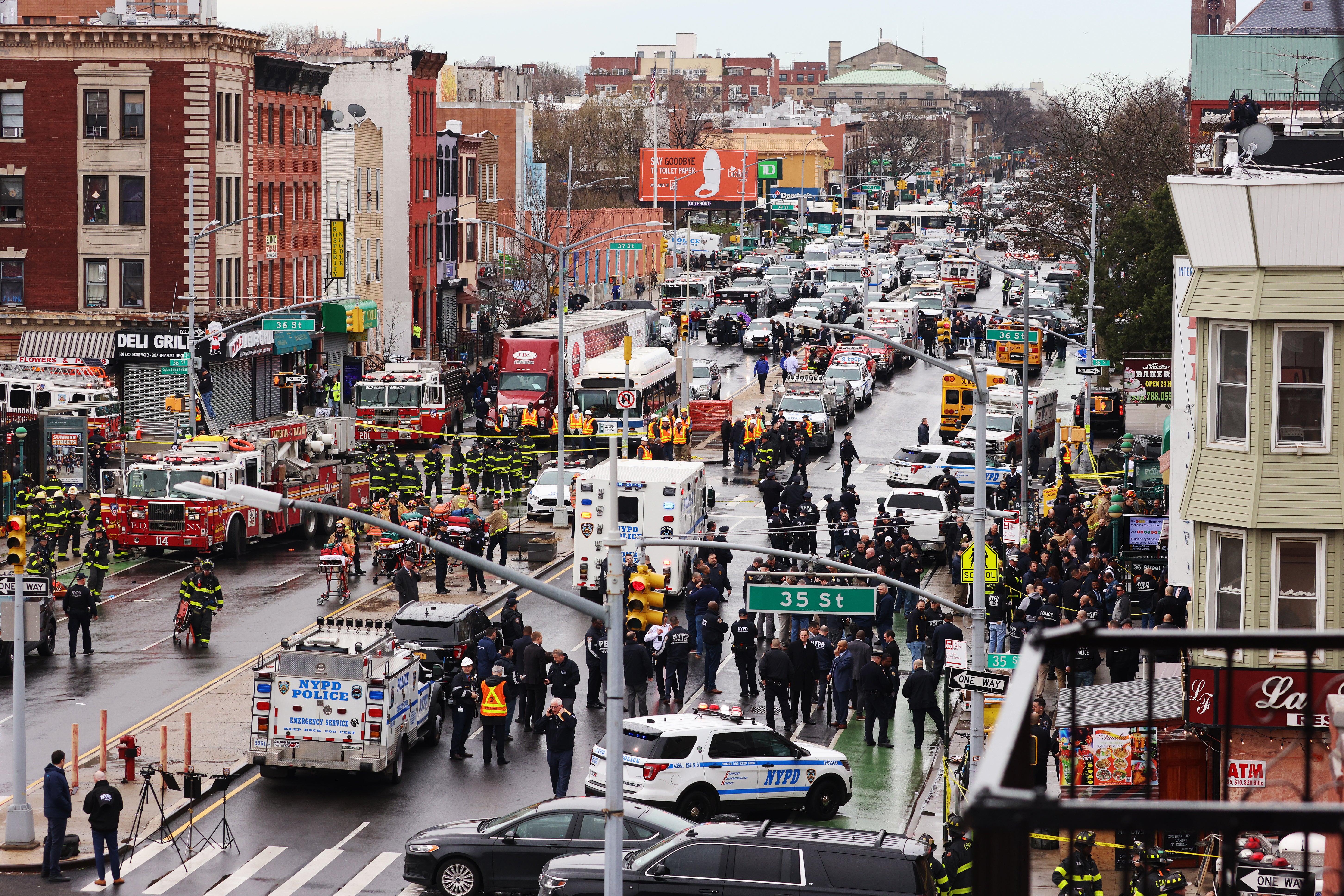 Crowds surround law enforcement investigating a subway attack in Brooklyn on 12 April