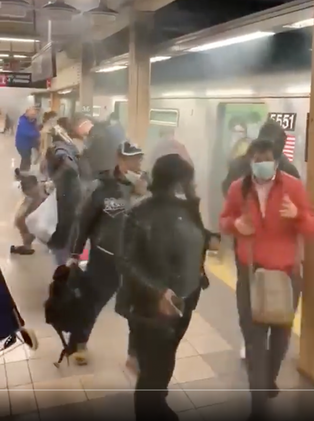 Terrified commuters flee from a smoke-filled carriage after the Brooklyn subway attack on Tuesday morning