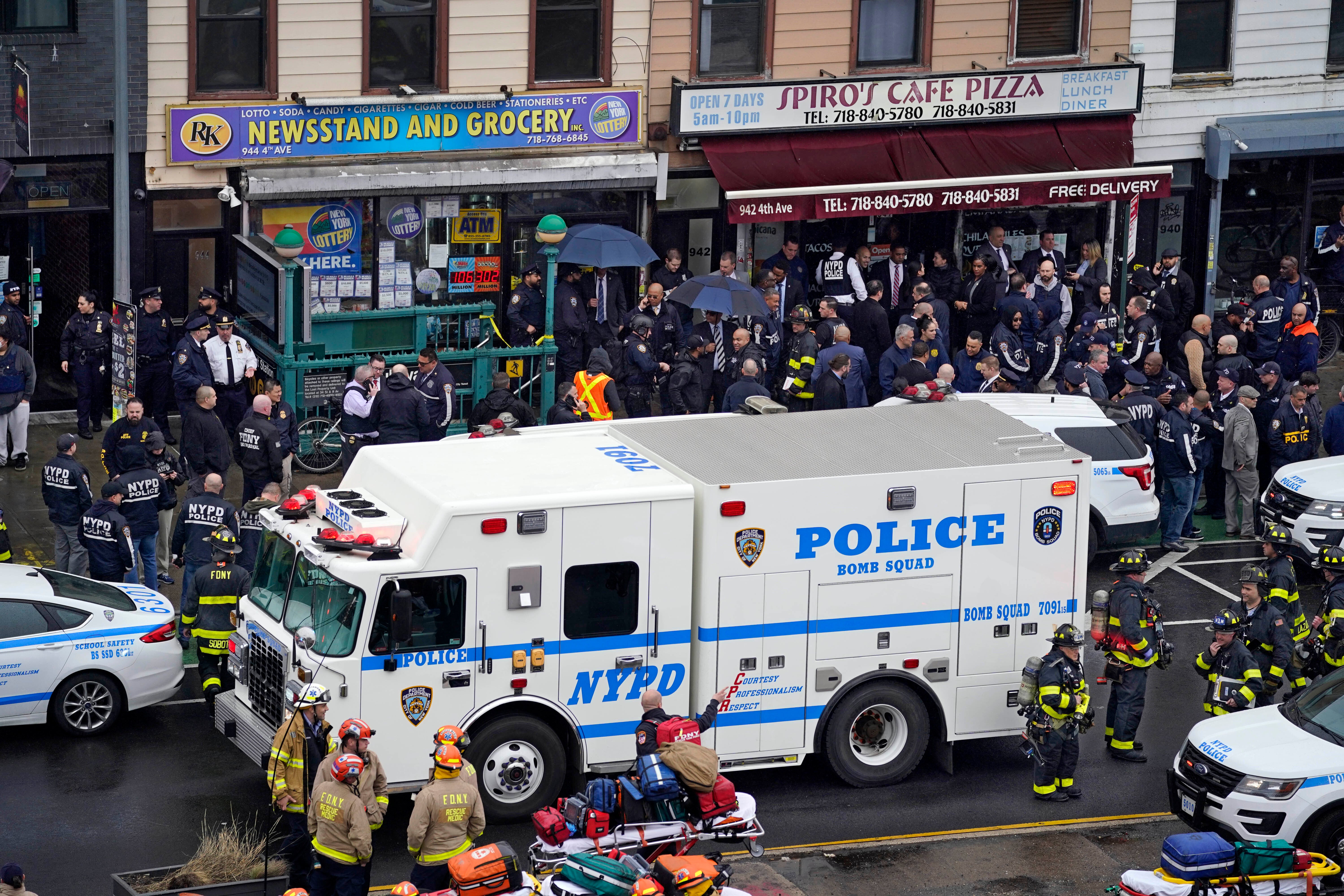 Emergency personnel gather at the entrance to a subway stop in the Brooklyn borough of New York, Tuesday, April 12, 2022. A gunman filled a rush-hour subway train with smoke and shot multiple people