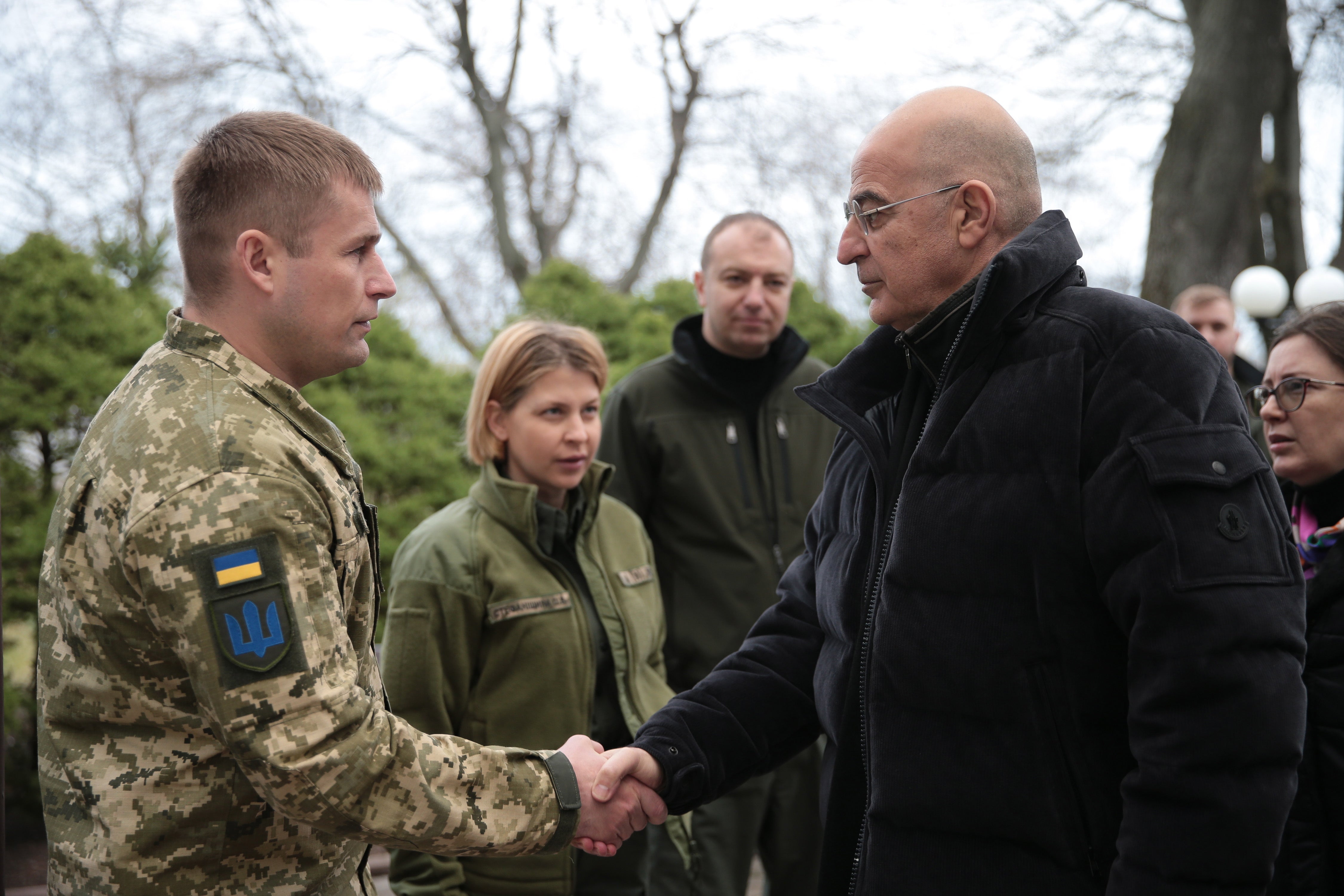 Greek foreign minister Nikos Dendias shakes hands with Col Maksym Marchenko, head of the Odesa Regional Military Administration, in Odesa, Ukraine