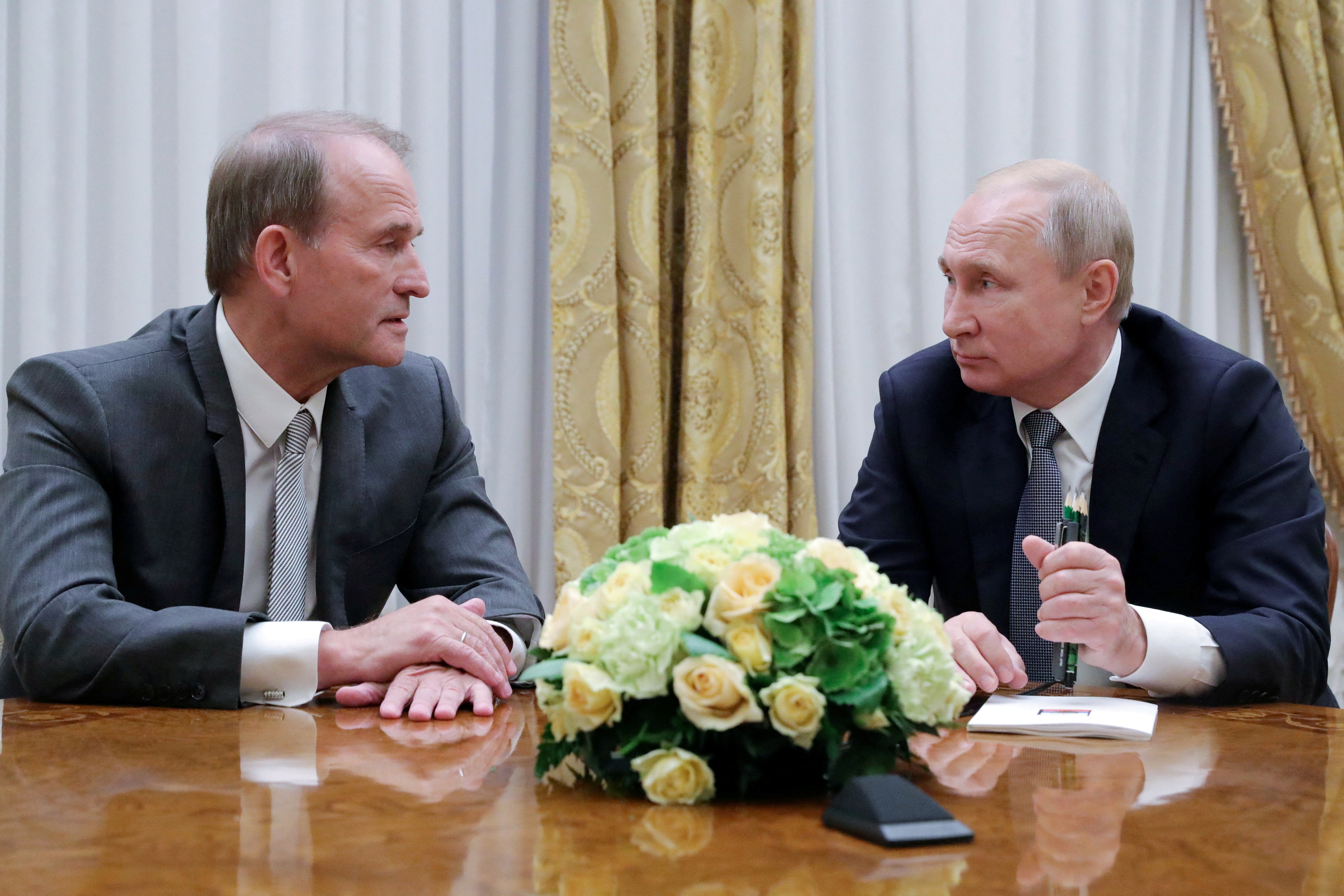 Russia’s president Vladimir Putin (R) attends a meeting with lMedvedchuk in Saint Petersburg, Russia, on 18 July 18 2019