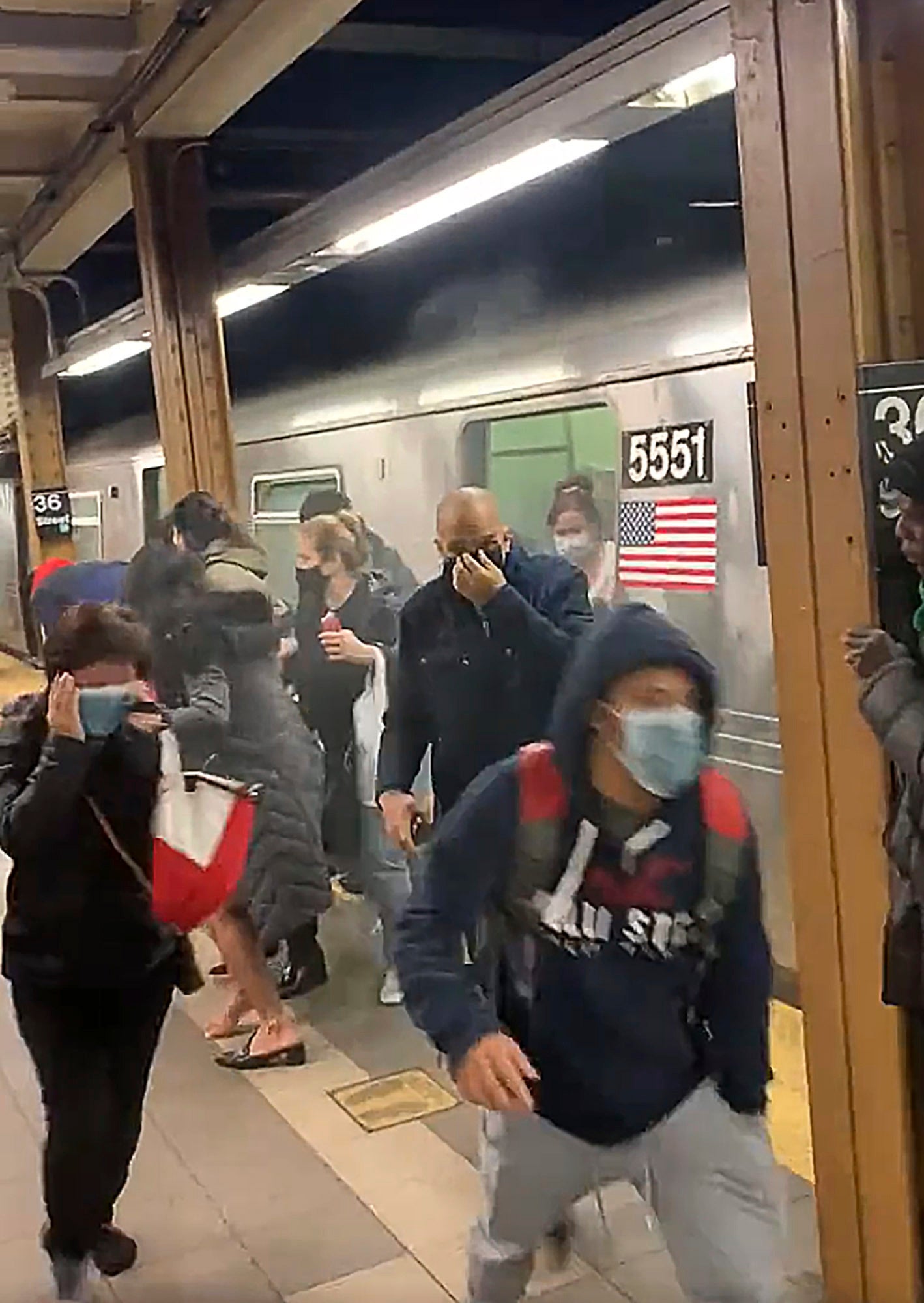 Terrified people running from a subway car