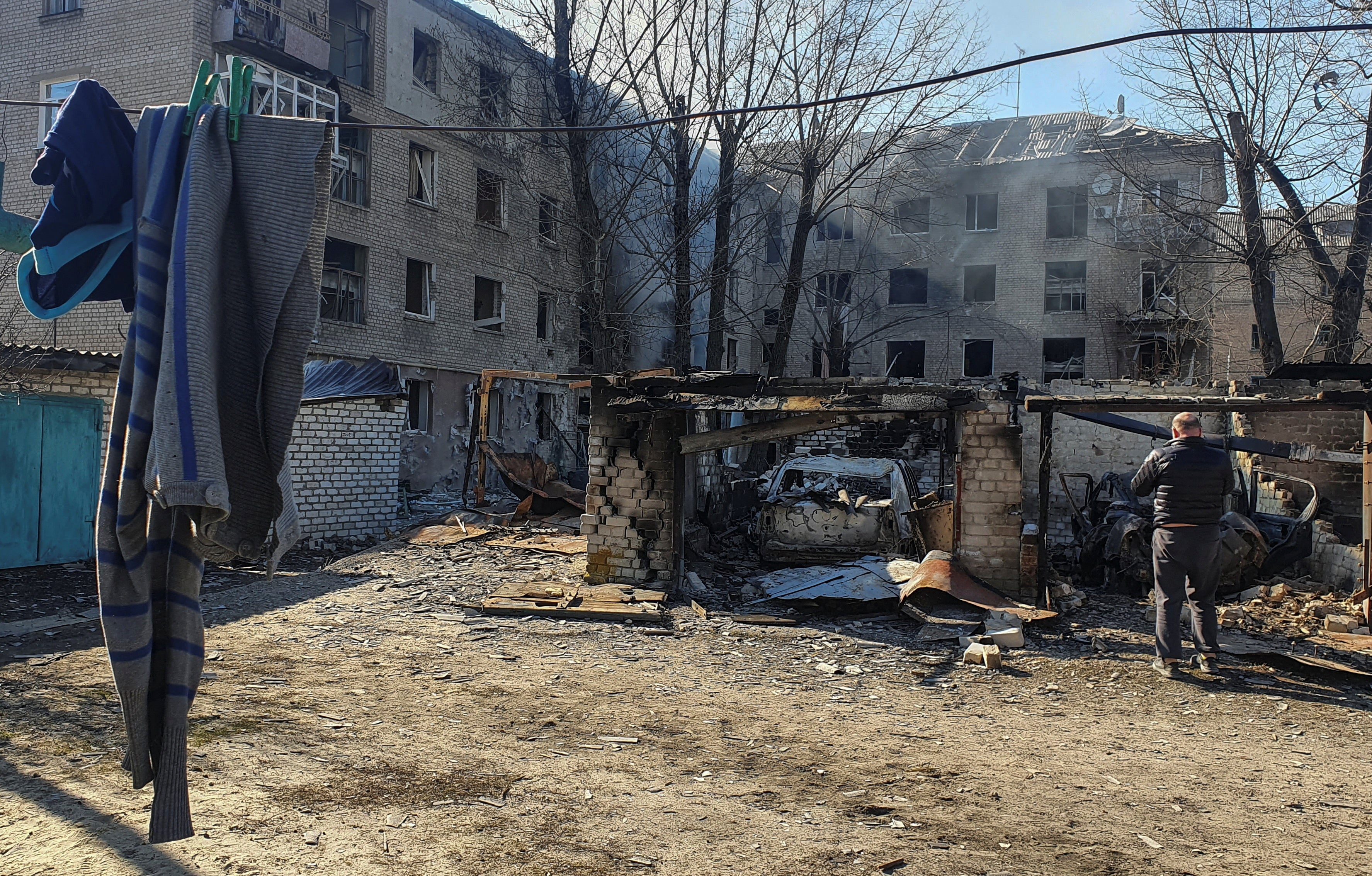 File photo: A man stands next to cars destroyed by shelling in Rubizhne, Luhansk, Ukraine, 24 March 2022