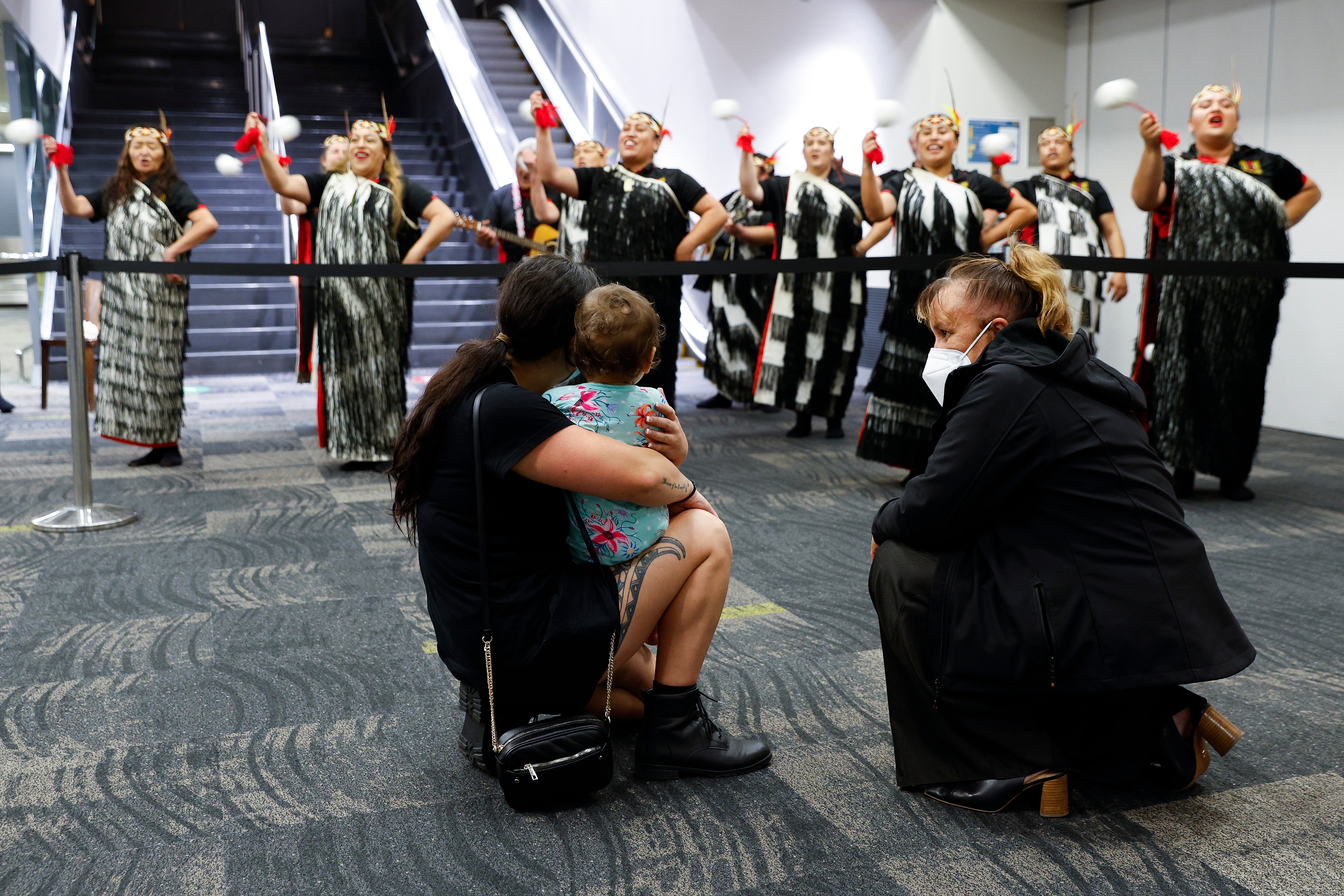 Arrivals watch a Maori cultural group perform at Wellington International Airport