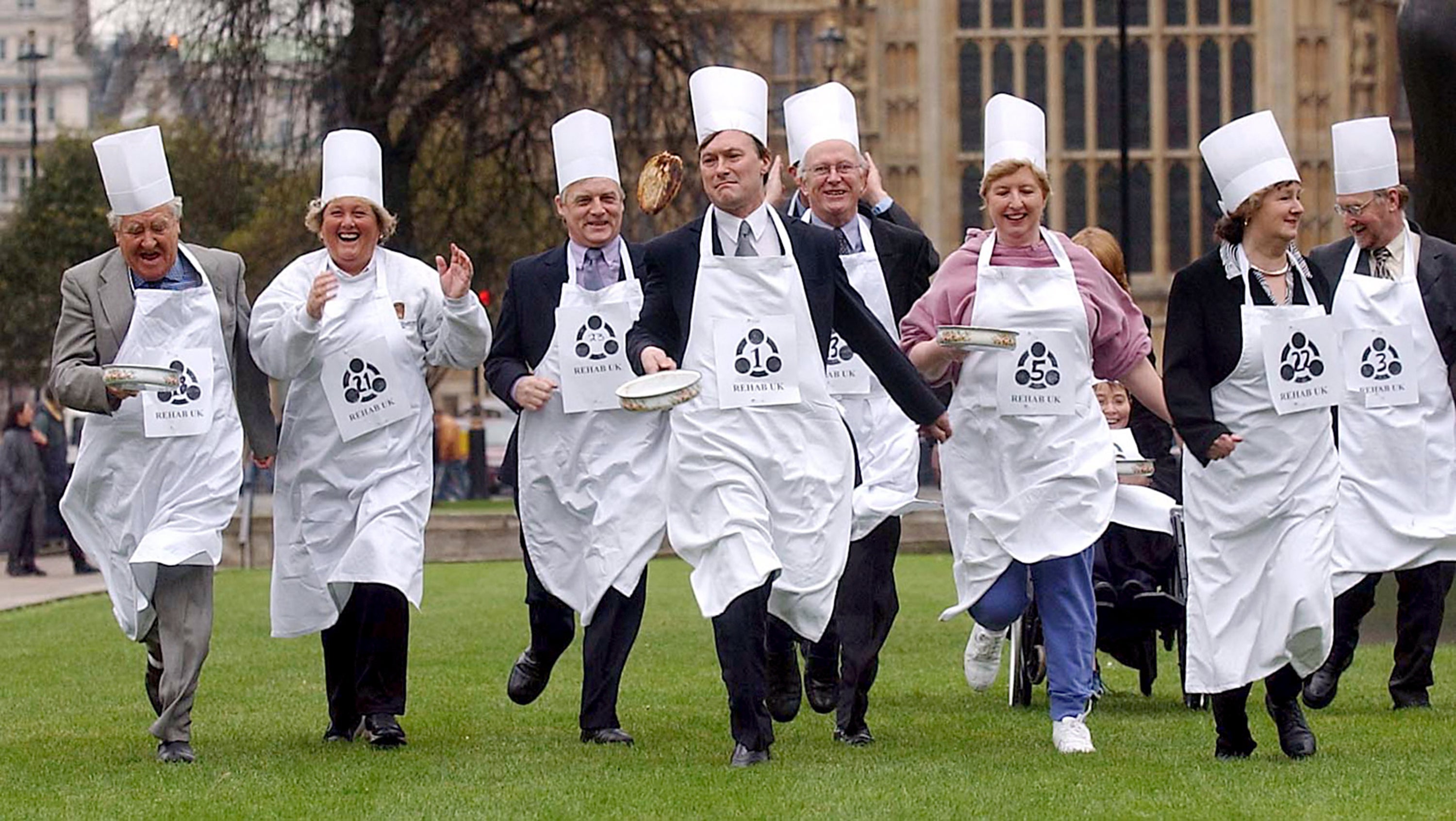 Sir David Amess leads the way in a pancake competition between the House of Commons and the House of Lords