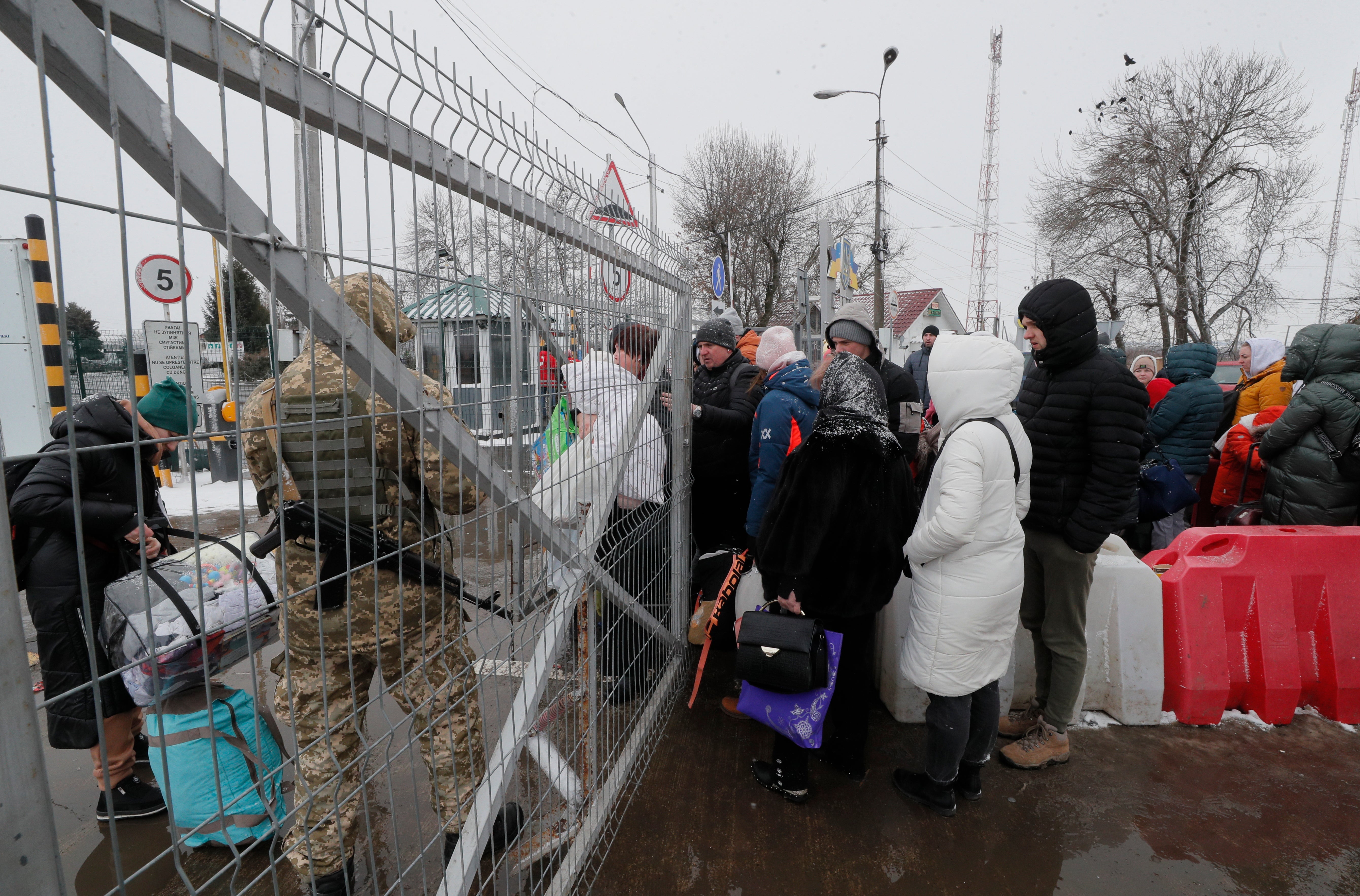 People wait in line on the Ukraine-Romania border crossing, not far from Chernivtsi