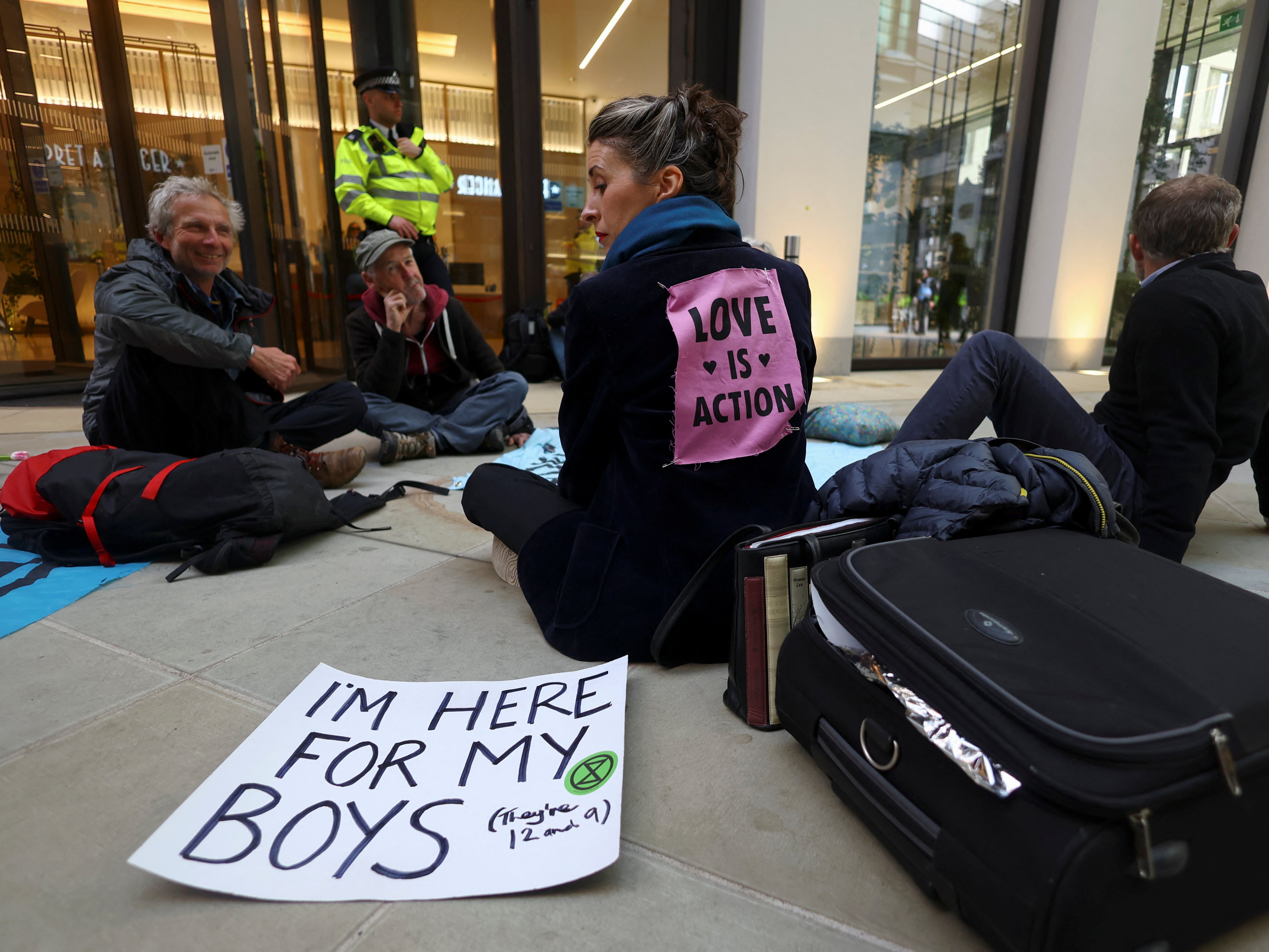 Activists from Extinction Rebellion glue themselves outside Shell's headquarters