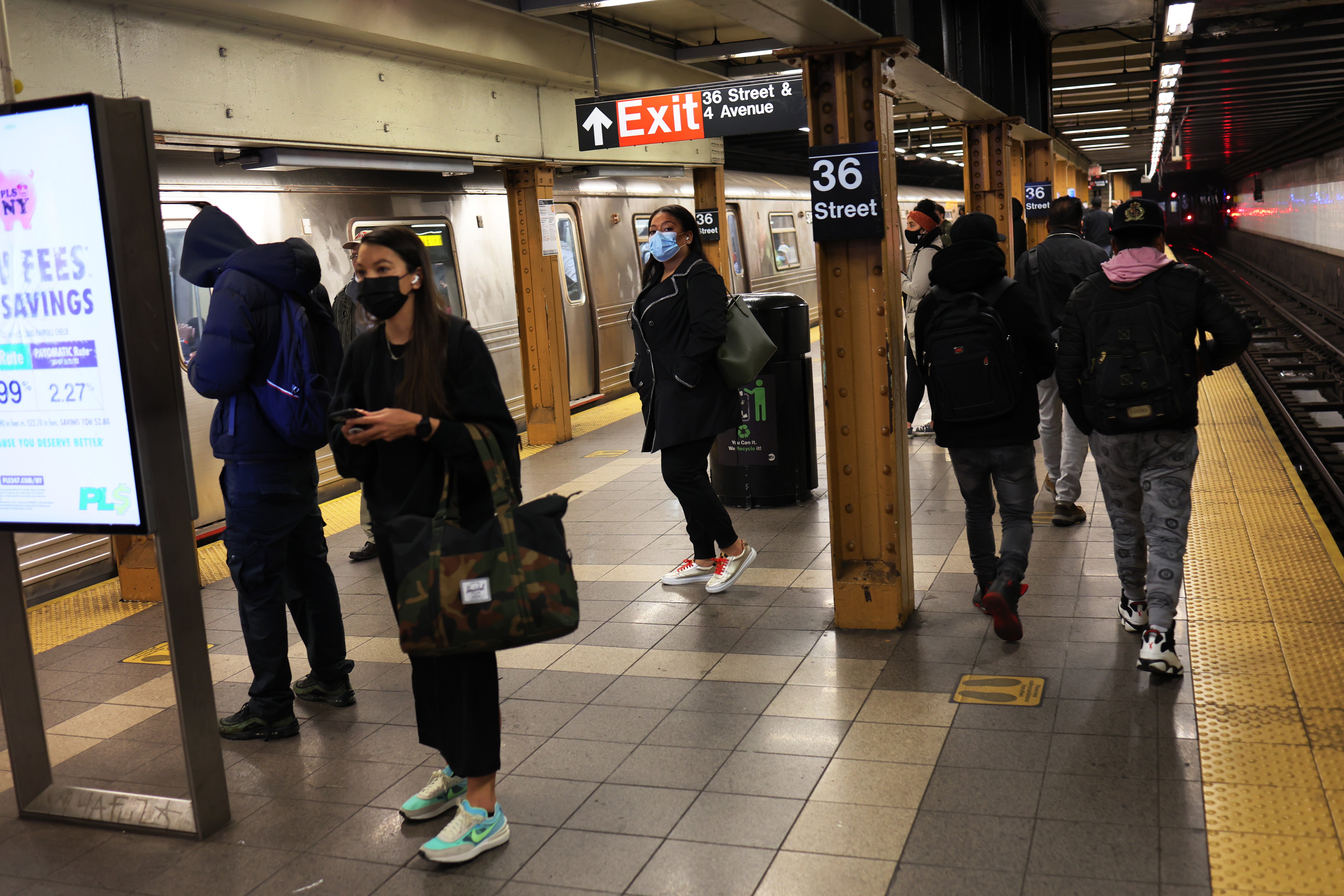 New Yorkers wait for the train at the 36 Street subway station on 13 April